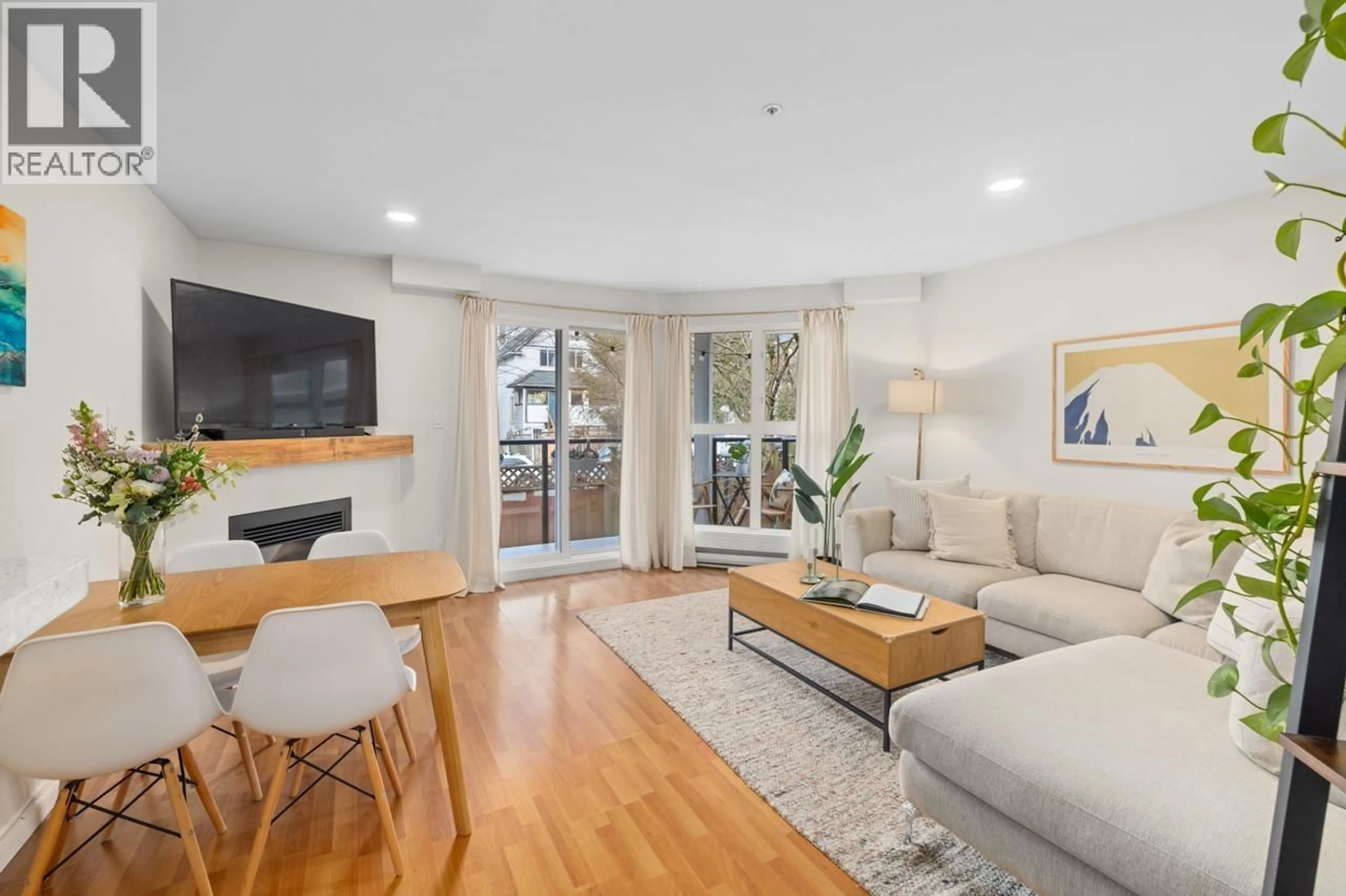 Living room with furniture, wood/laminate floor for 205 - 2212 OXFORD STREET, Vancouver British Columbia V5L1G1