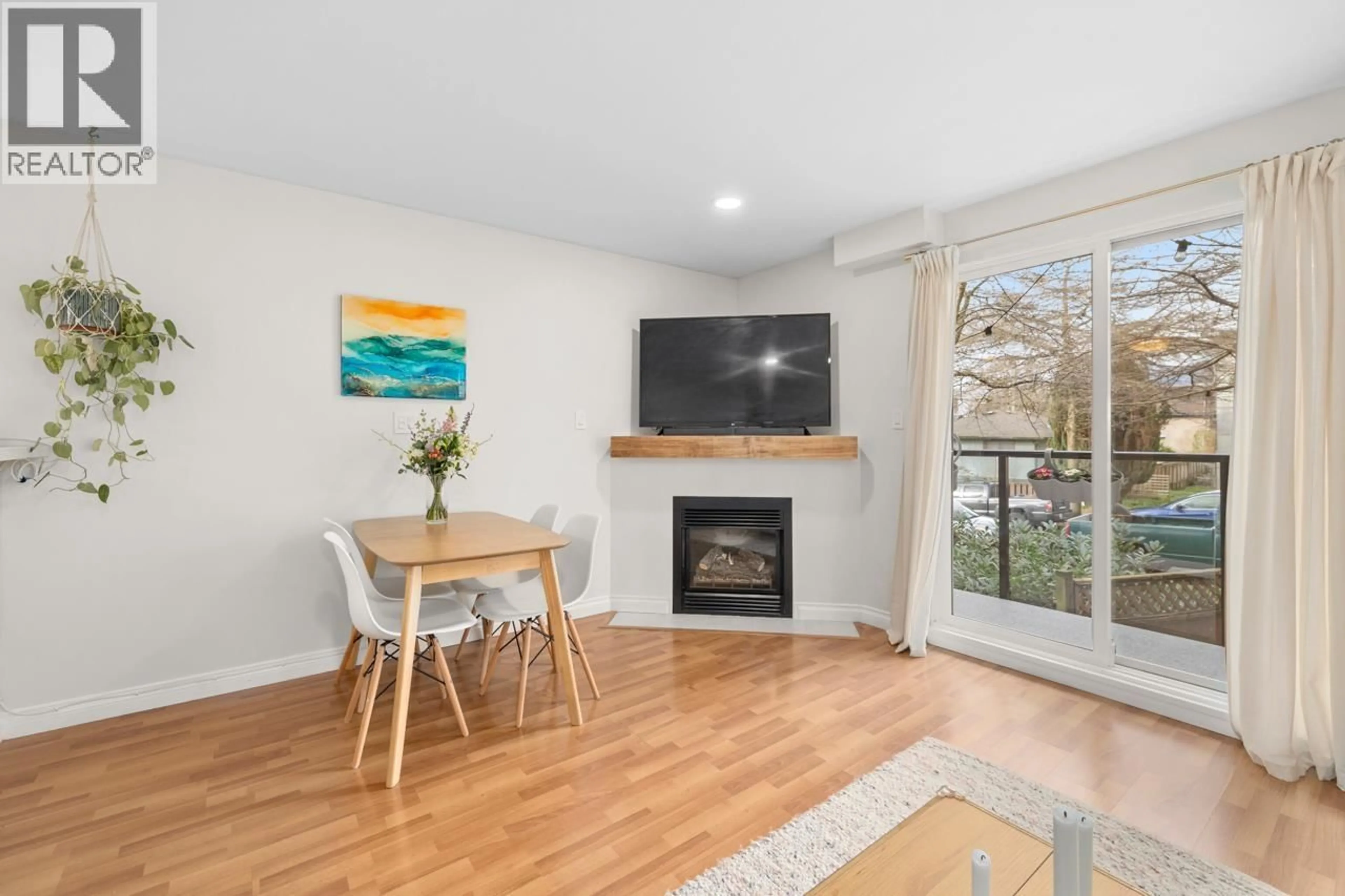 Living room with furniture, wood/laminate floor for 205 - 2212 OXFORD STREET, Vancouver British Columbia V5L1G1