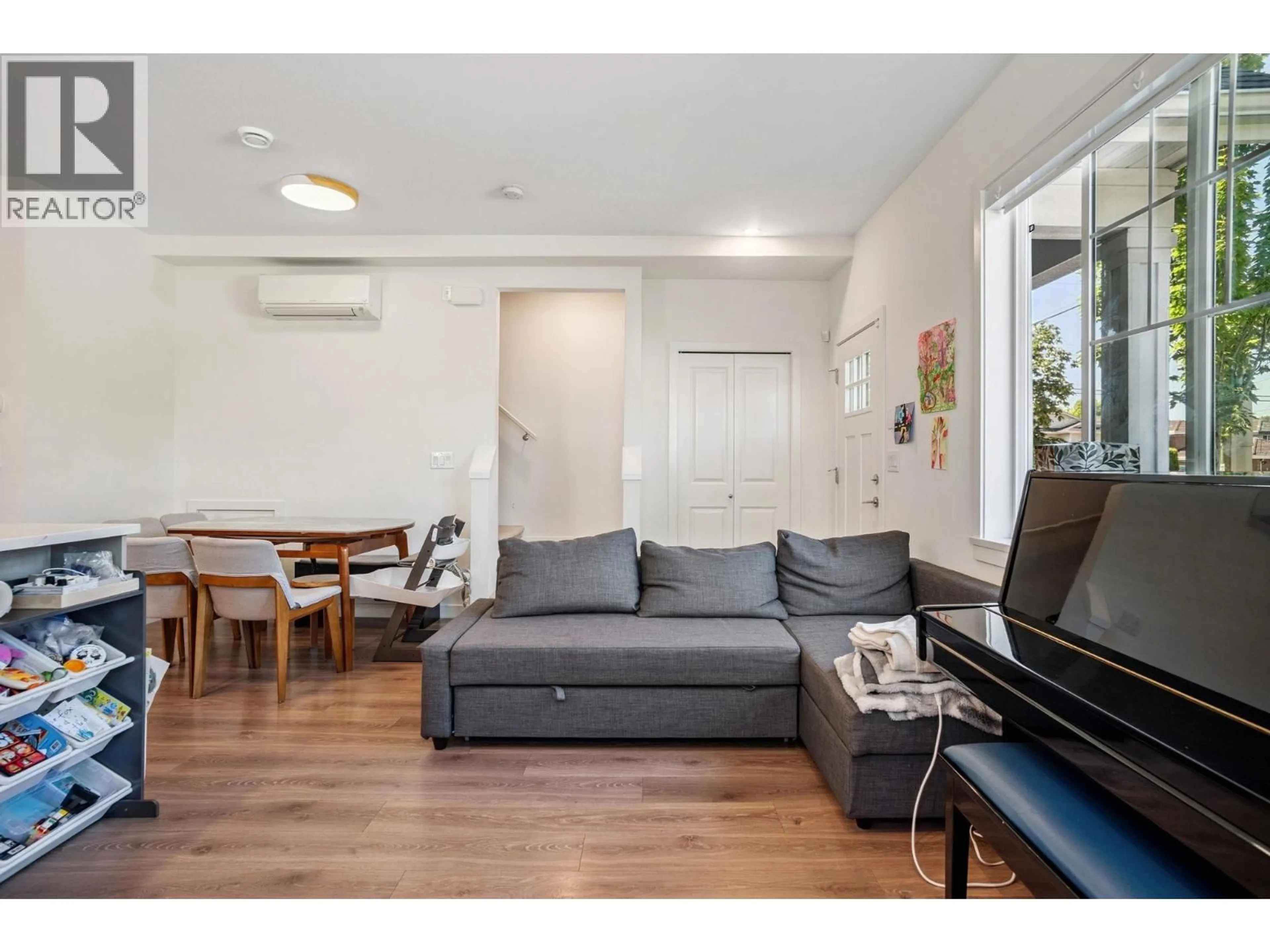 Living room with furniture, wood/laminate floor for 1 - 7780 BRIDGE STREET, Richmond British Columbia V6Y0L2