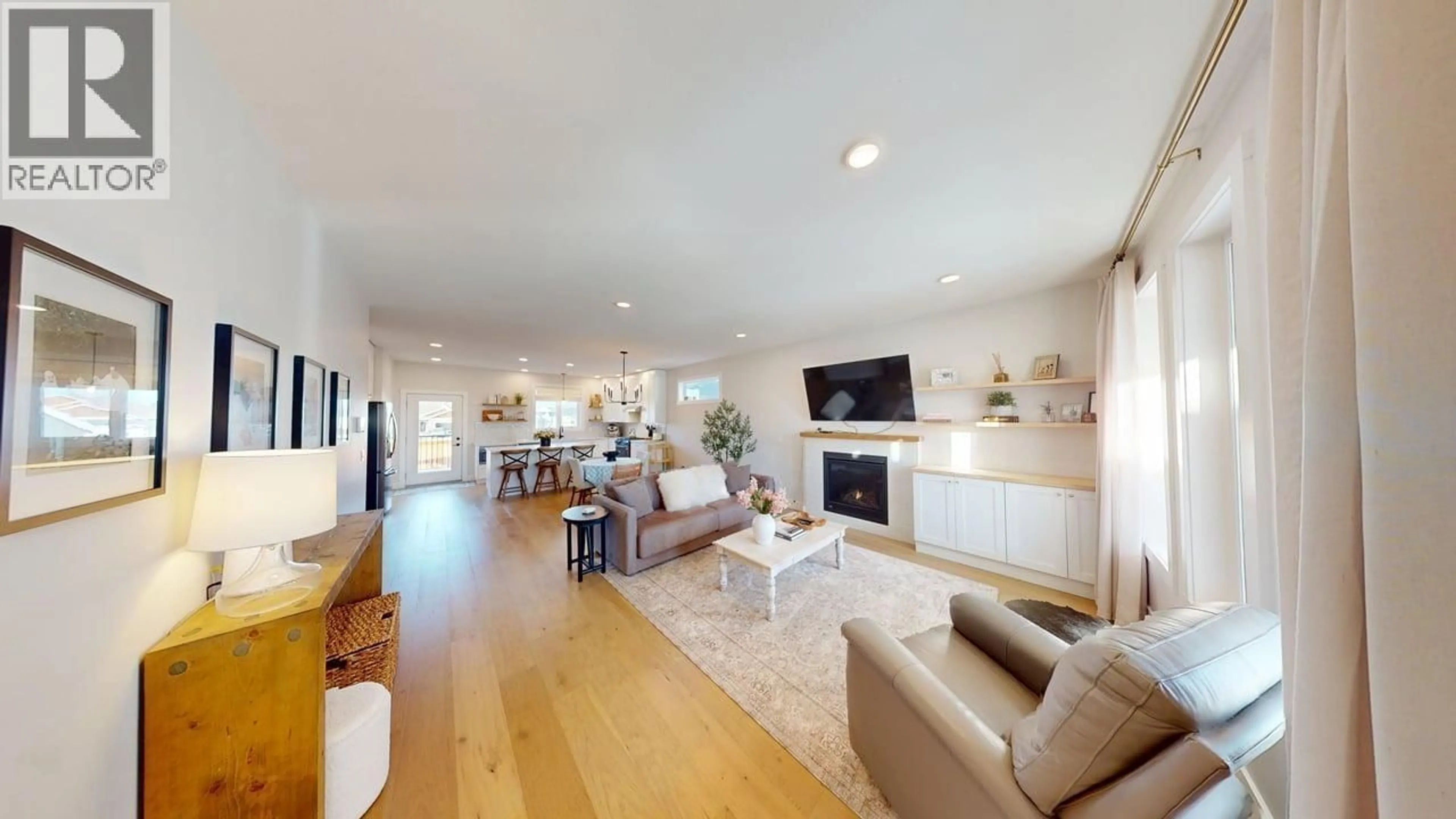 Living room with furniture, wood/laminate floor for 11220 112 AVENUE, Fort St. John British Columbia V1J0R5