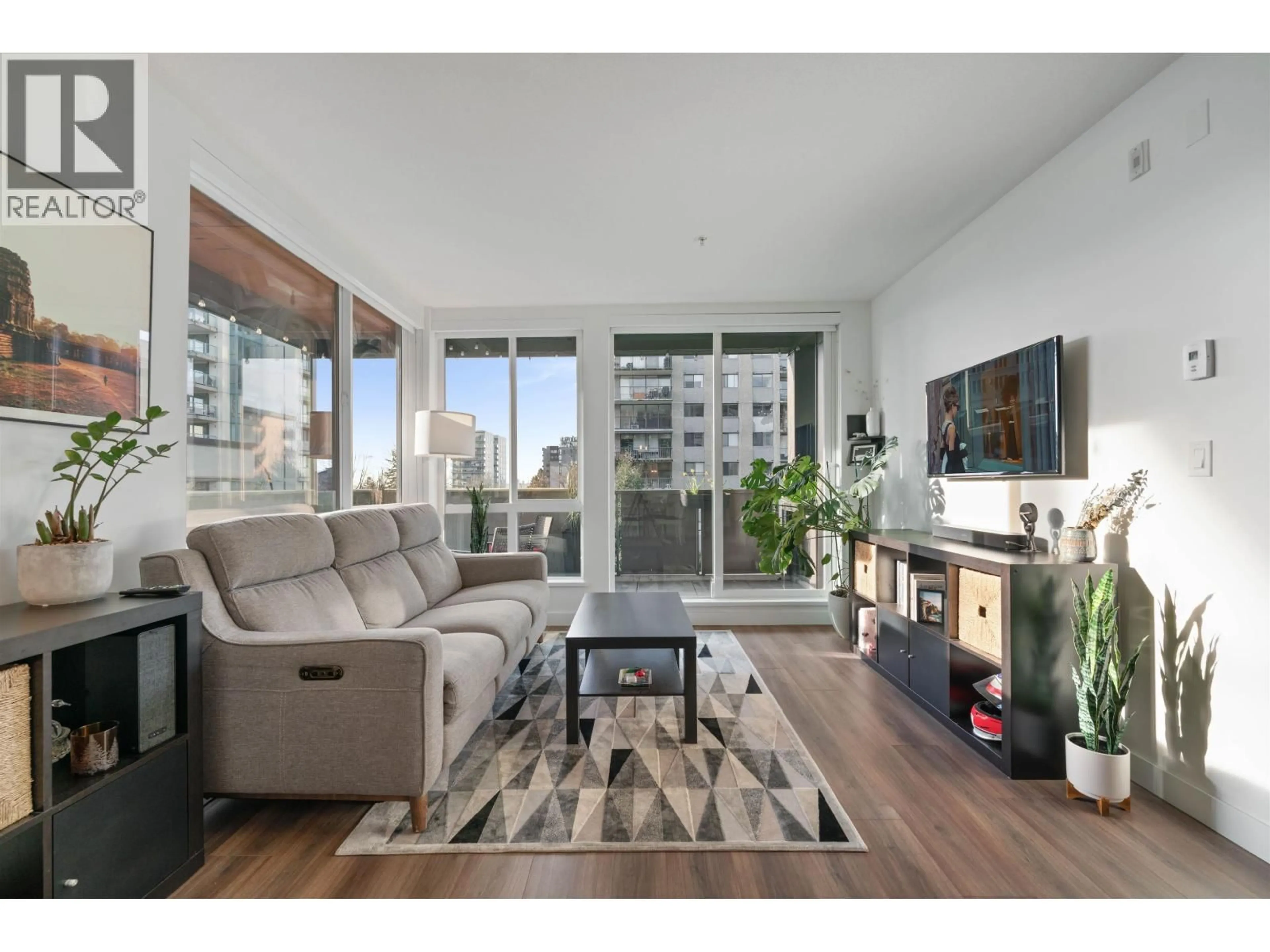 Living room with furniture, wood/laminate floor for 201 - 108 8TH STREET, North Vancouver British Columbia V7L0H1