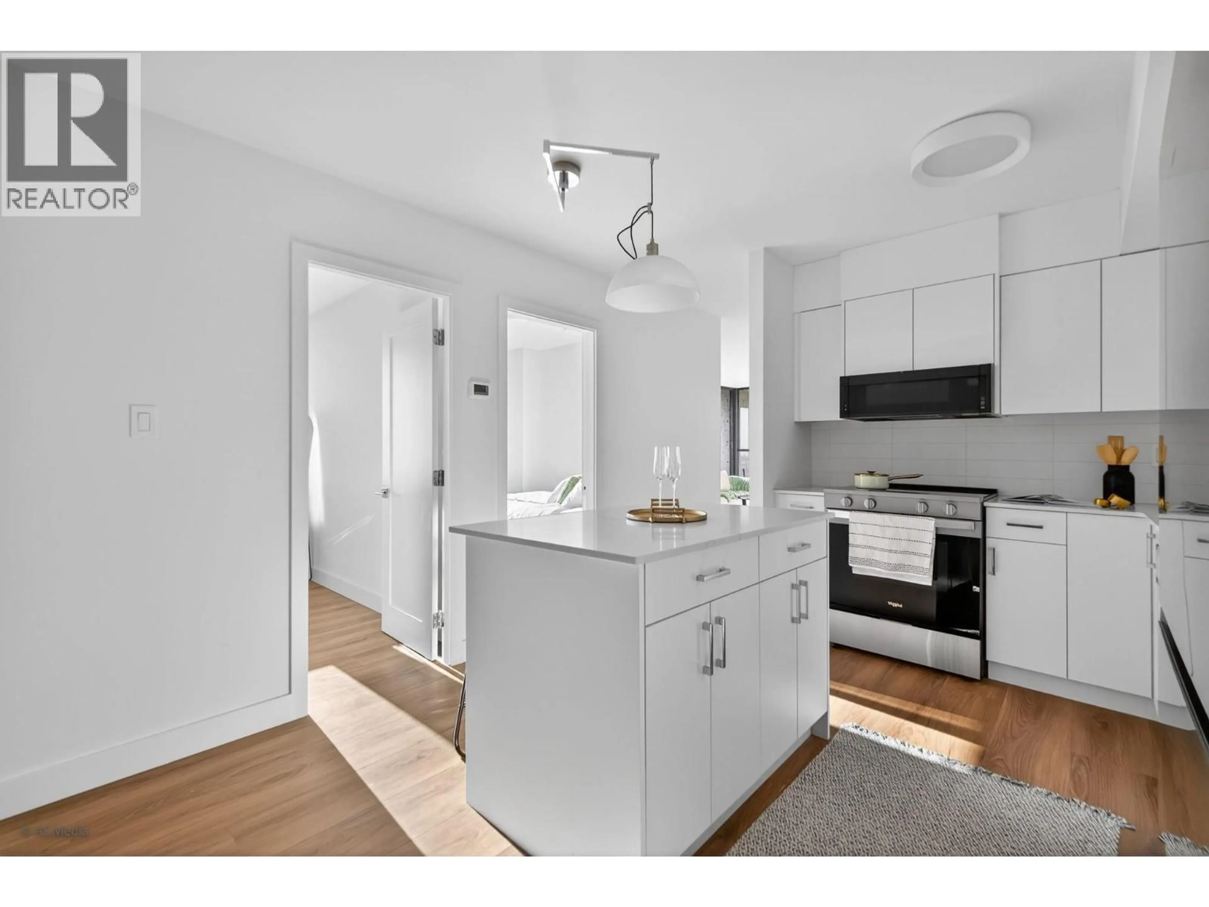 Open concept kitchen, wood/laminate floor for 2206 - 3771 BARTLETT COURT, Burnaby British Columbia V3J7G8