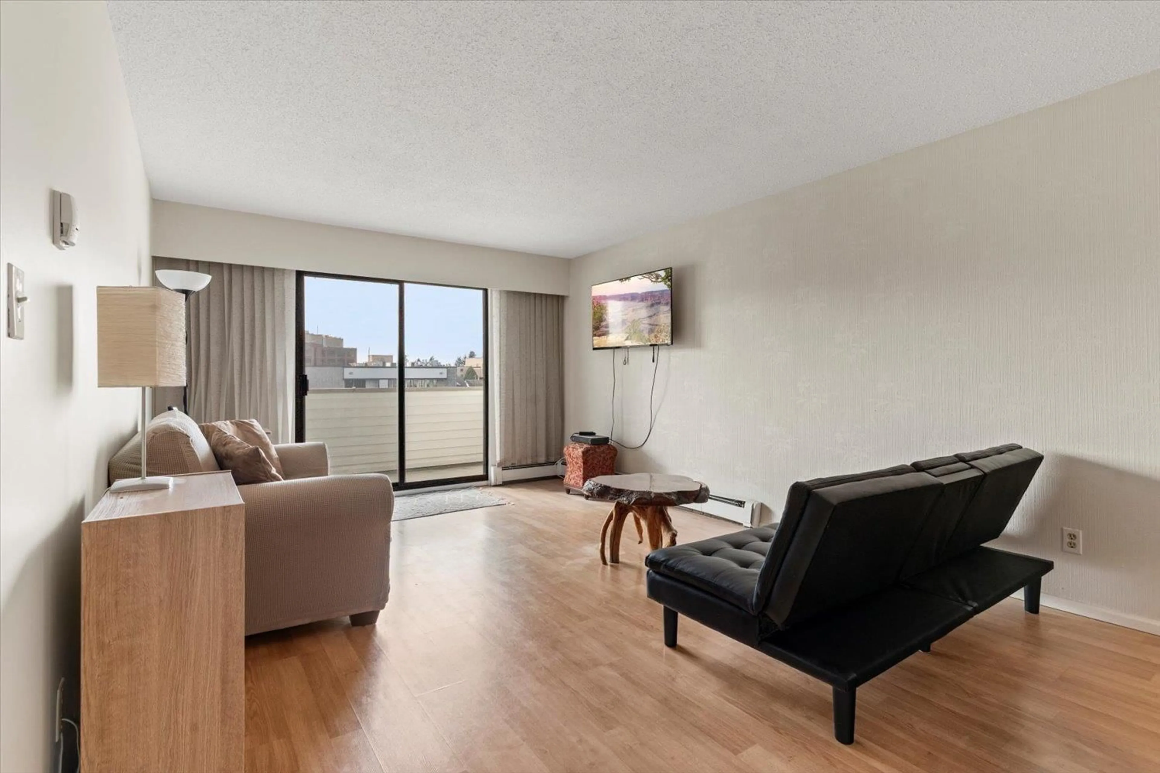 Living room with furniture, wood/laminate floor for 204 - 9175 MARY STREET, Chilliwack British Columbia V2P4H7