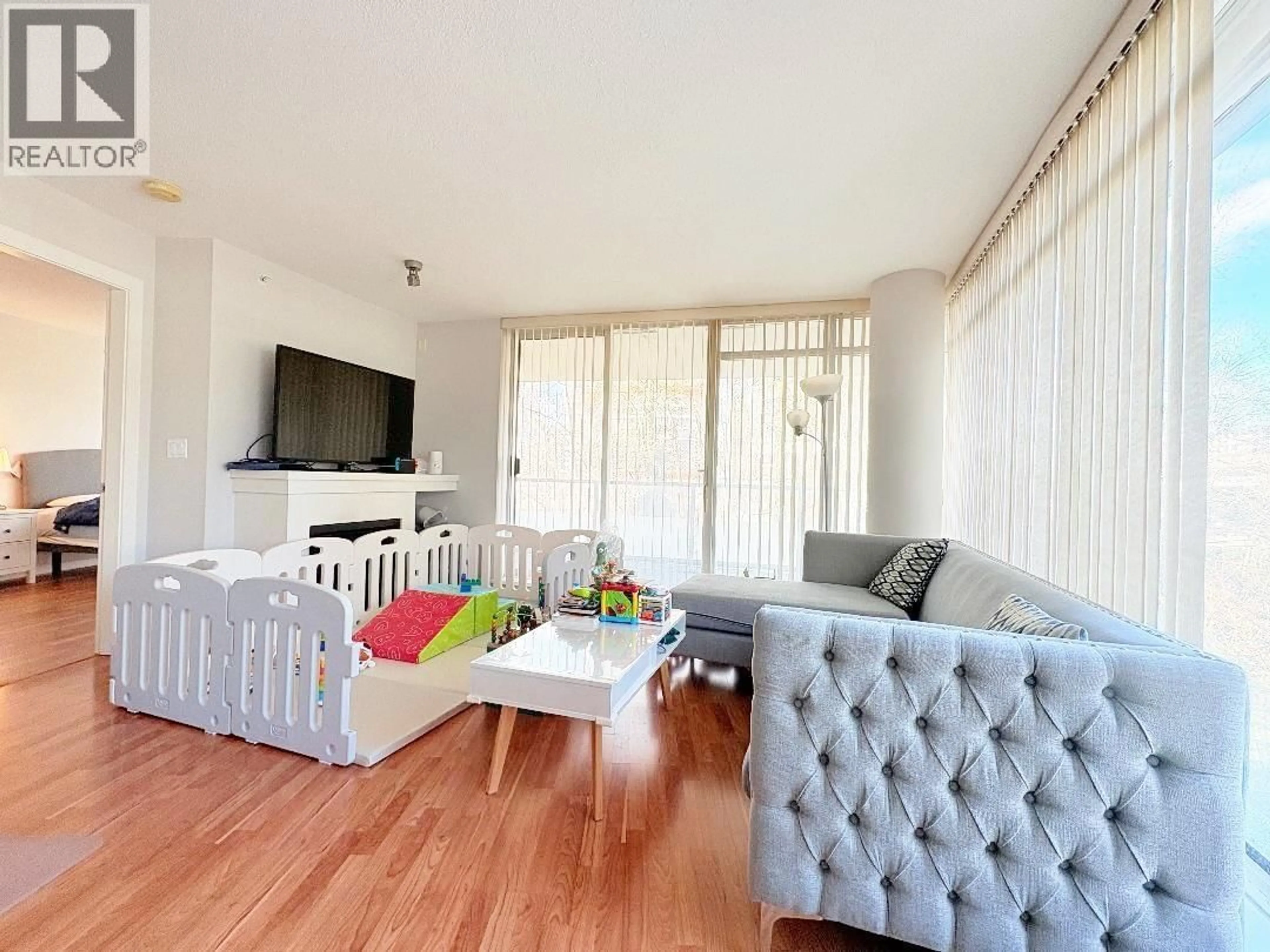 Living room with furniture, wood/laminate floor for 502 - 2133 DOUGLAS ROAD, Burnaby British Columbia V5C0E9