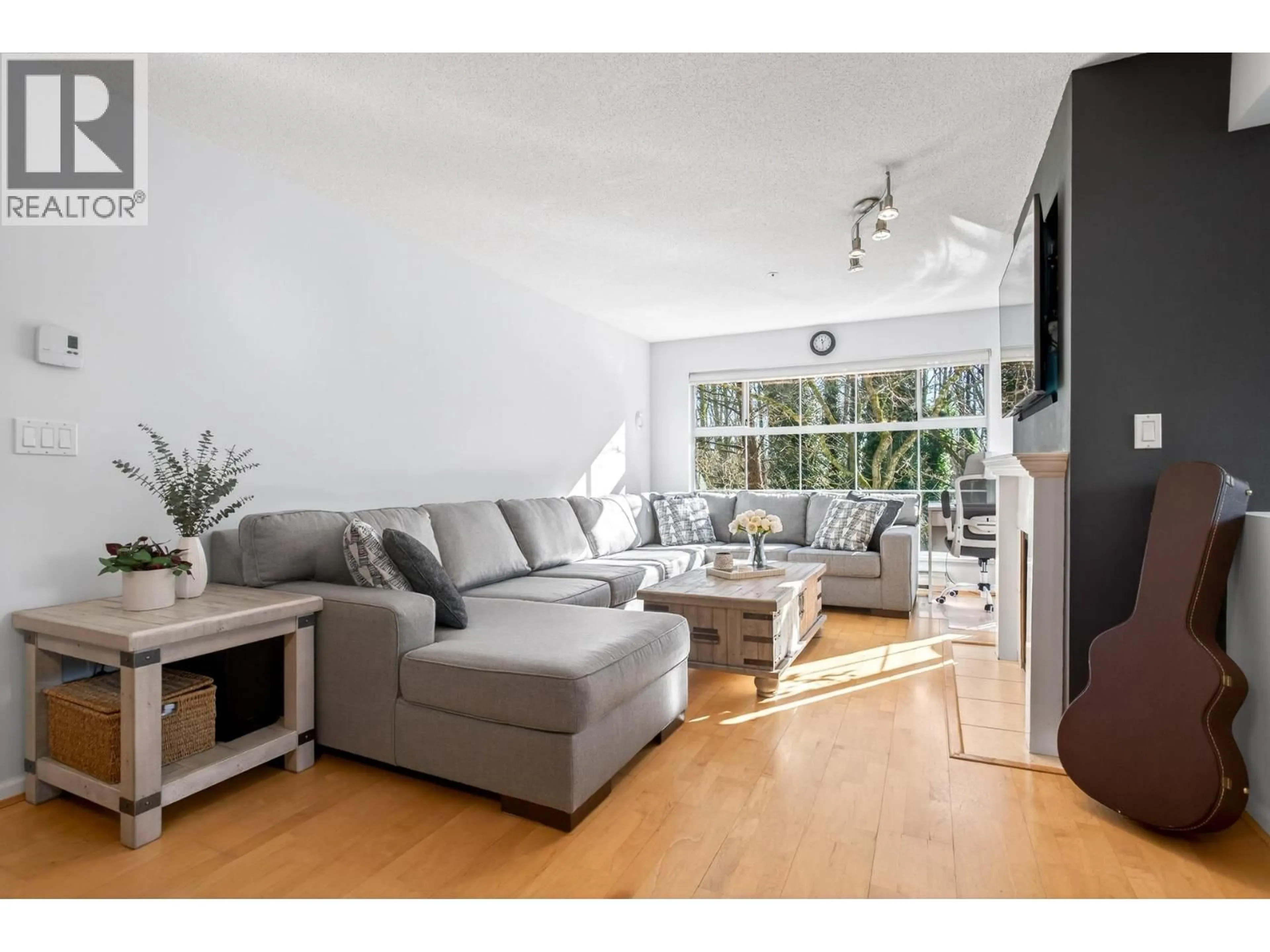 Living room with furniture, wood/laminate floor for 218 - 2678 DIXON STREET, Port Coquitlam British Columbia V3C6L7