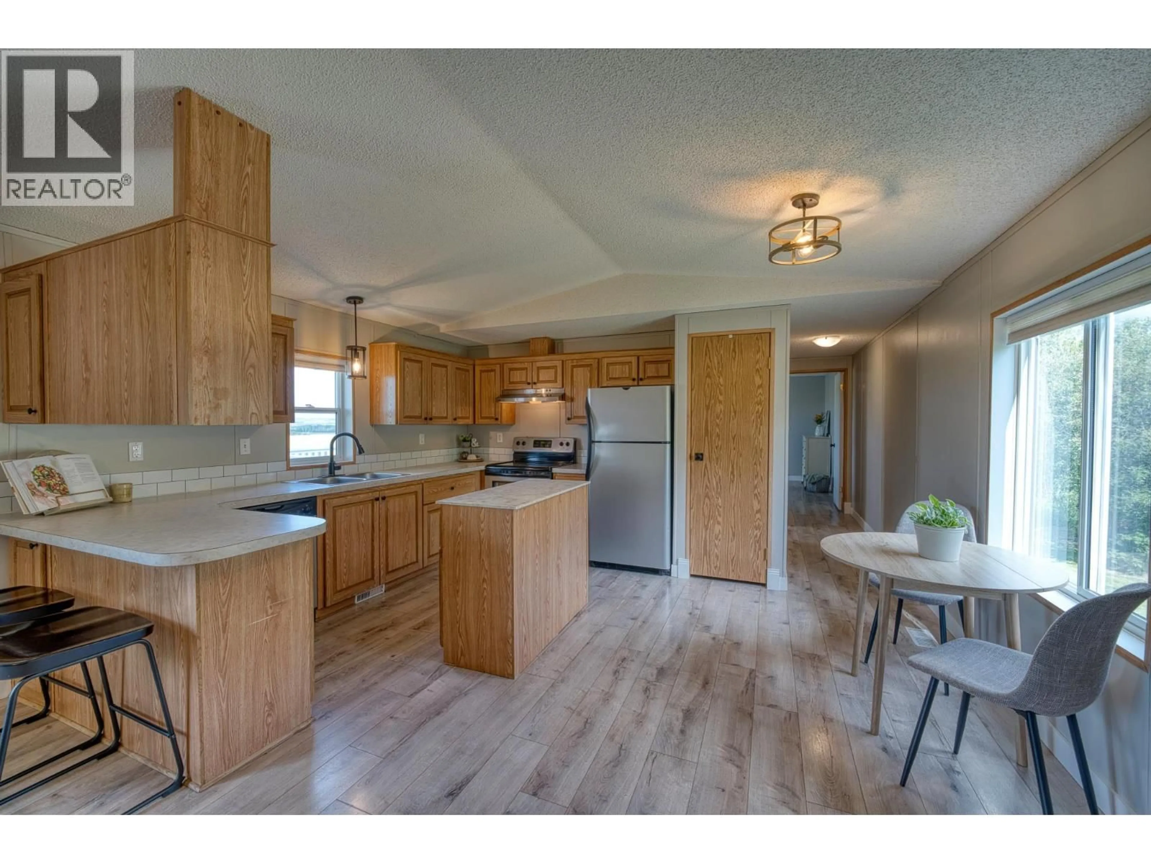 Open concept kitchen, wood/laminate floor for 11075 257 ROAD, Fort St. John British Columbia V1J8C2