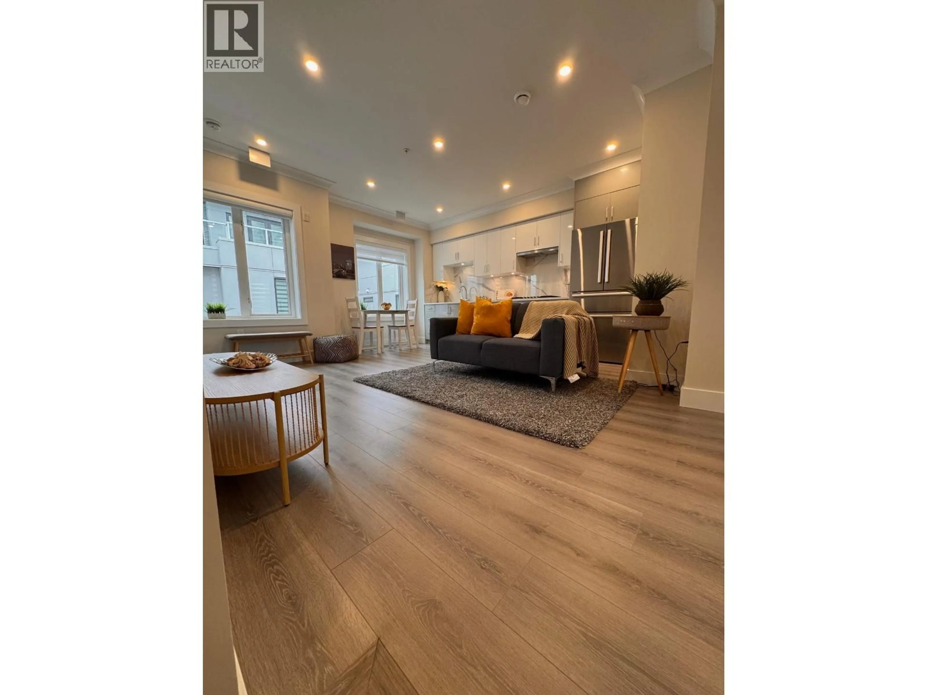 Living room with furniture, wood/laminate floor for 8319 FRENCH STREET, Vancouver British Columbia V6P4W3
