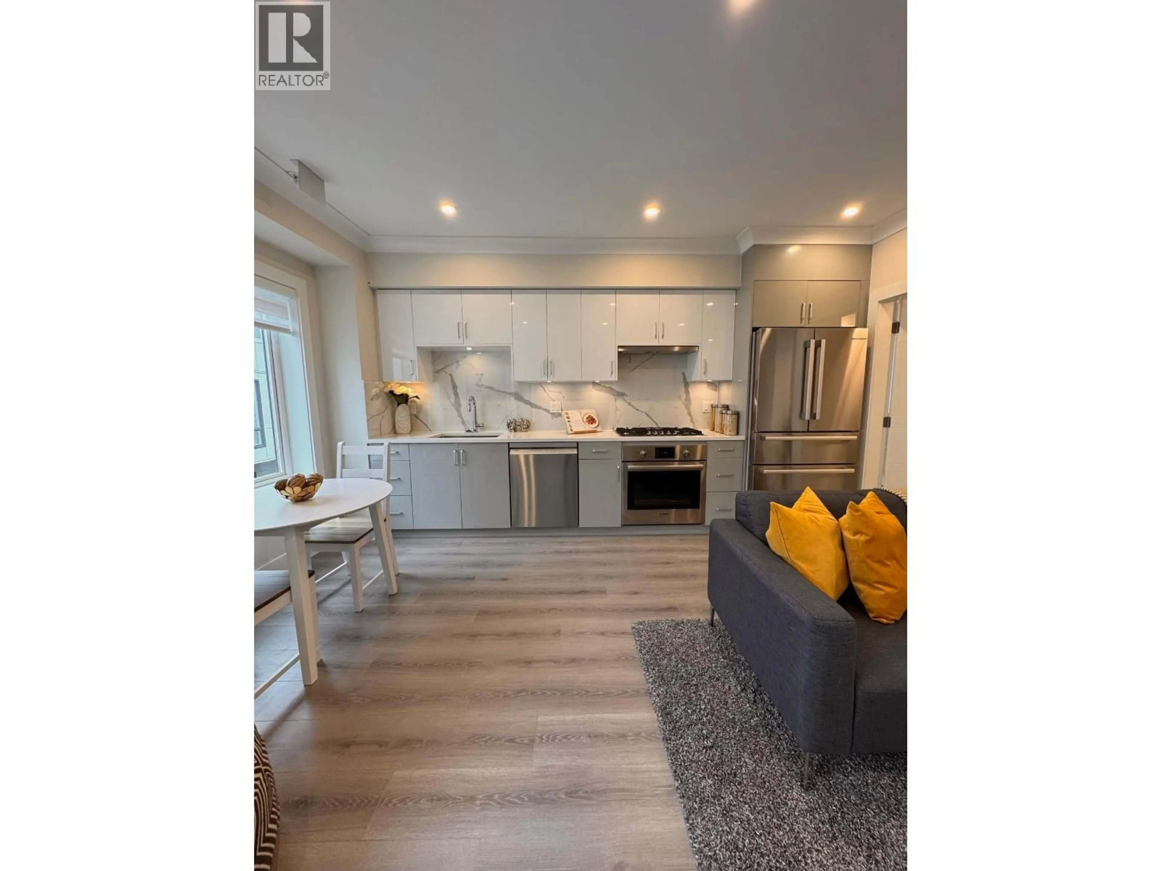 Open concept kitchen, wood/laminate floor for 8319 FRENCH STREET, Vancouver British Columbia V6P4W3