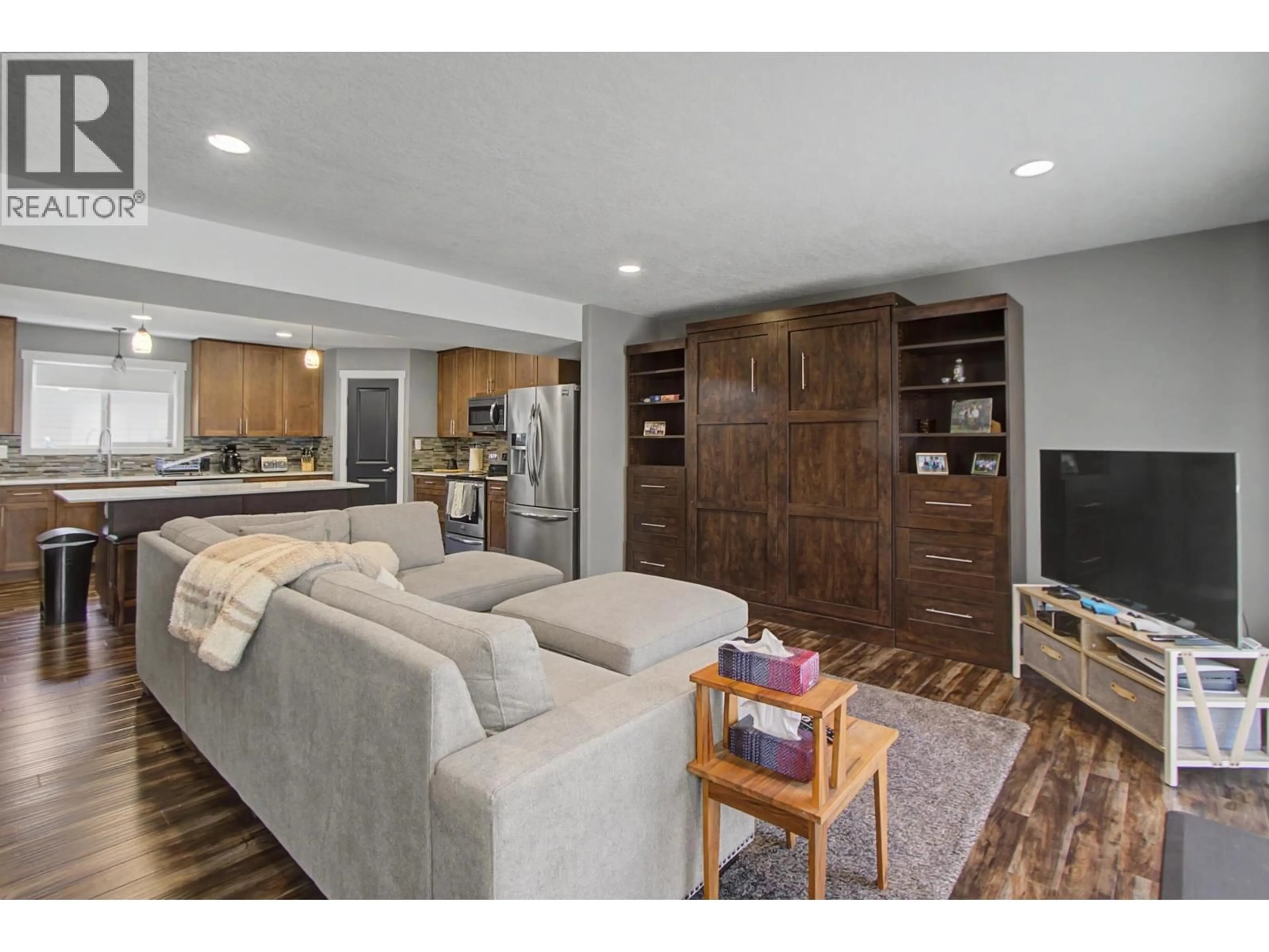 Living room with furniture, wood/laminate floor for 201 - 7400 CREEKSIDE WAY, Prince George British Columbia V2N0C2