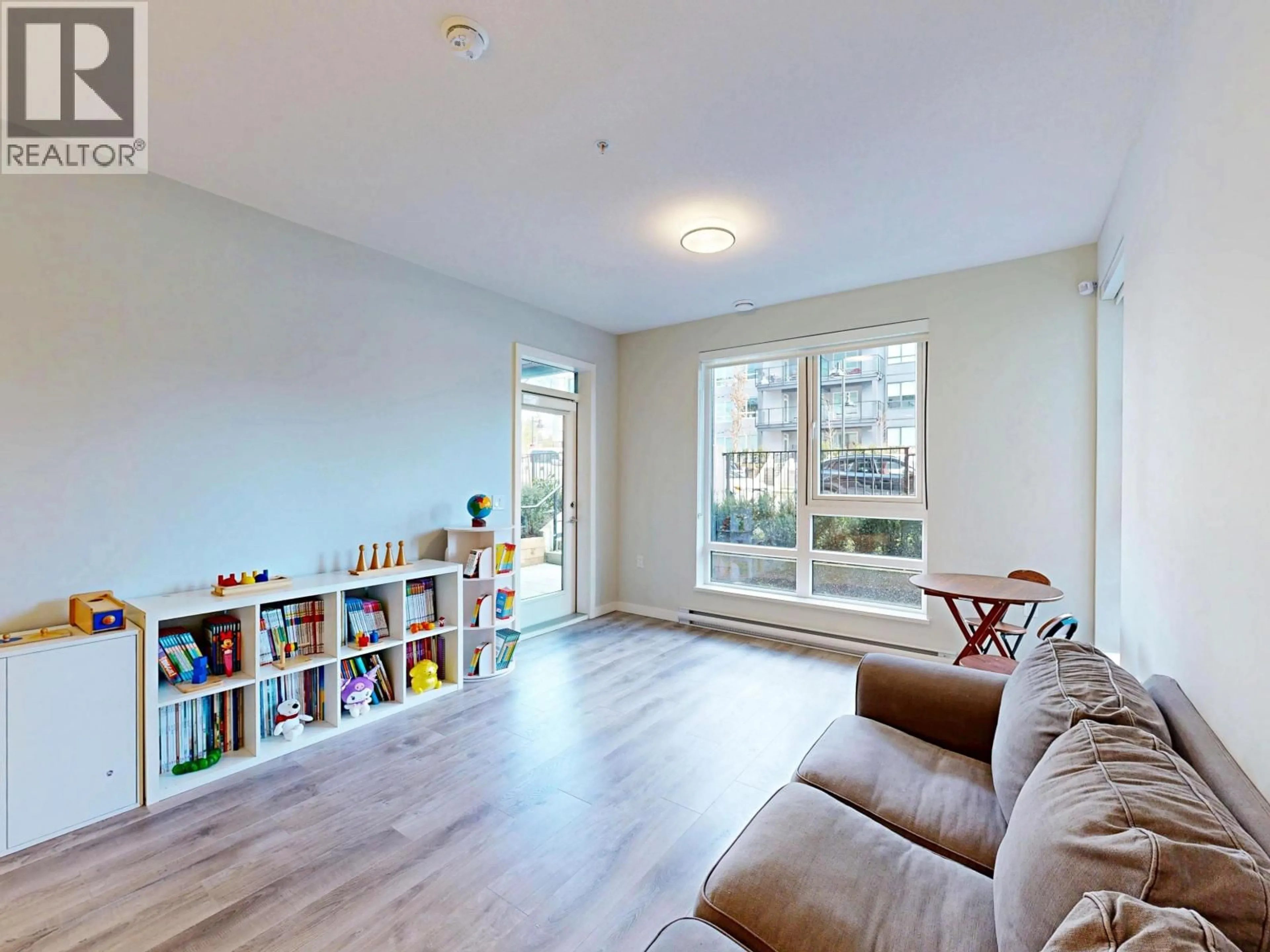 Living room with furniture, wood/laminate floor for 208 - 615 COTTONWOOD AVENUE, Coquitlam British Columbia V3J2S5