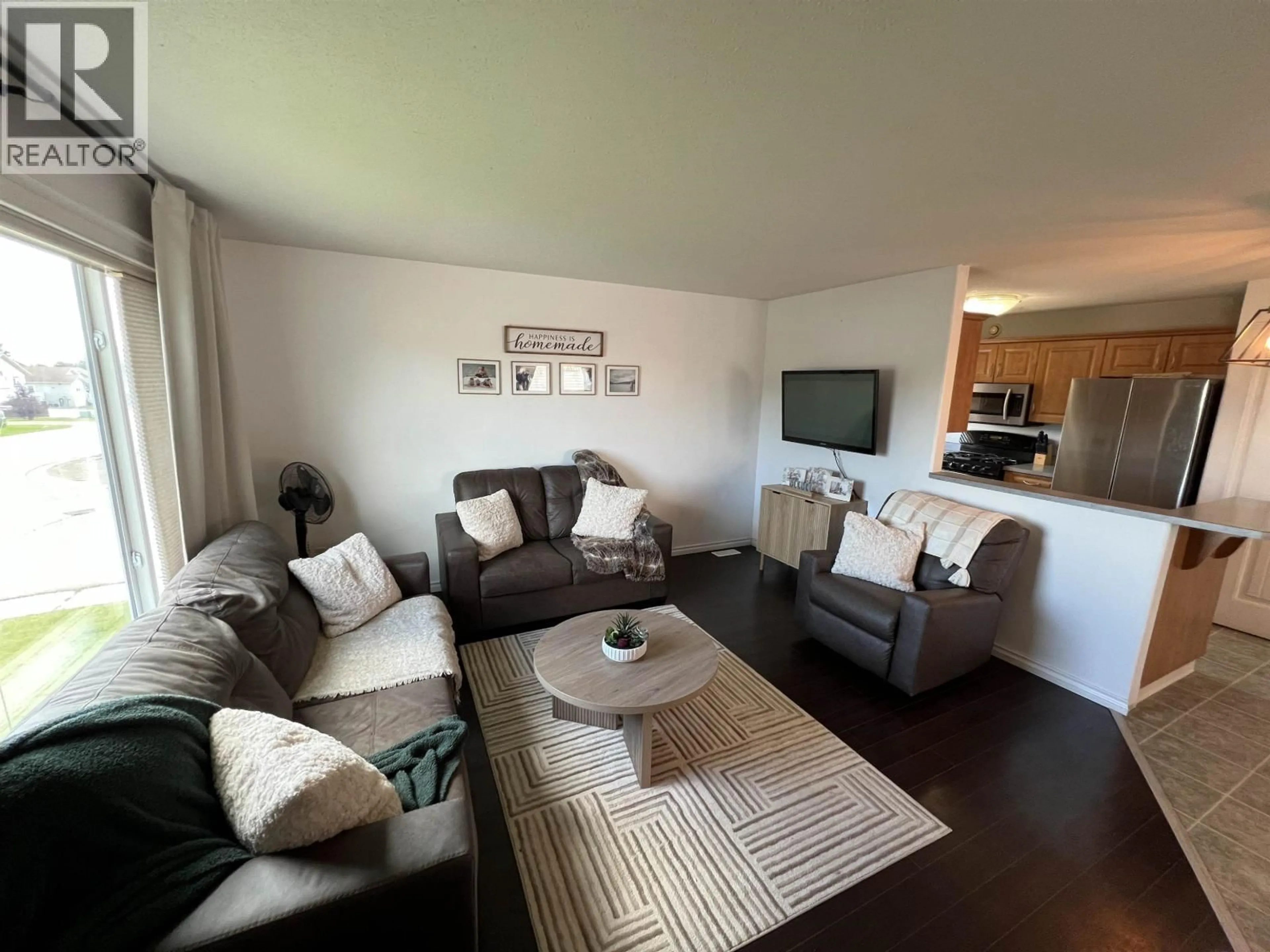 Living room with furniture, wood/laminate floor for 5201 HALLMARK CRESCENT, Fort Nelson British Columbia V0C1R0