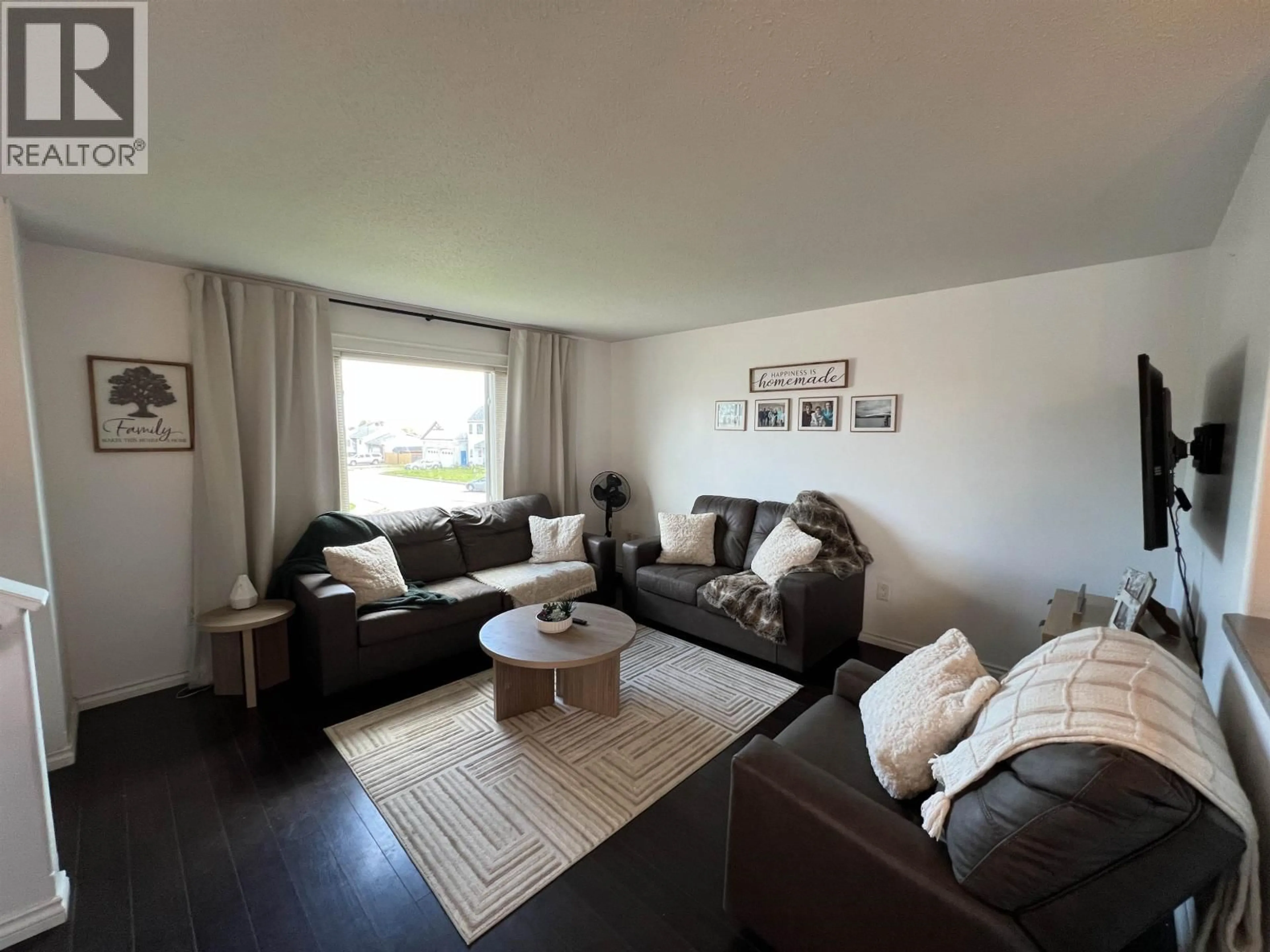 Living room with furniture, wood/laminate floor for 5201 HALLMARK CRESCENT, Fort Nelson British Columbia V0C1R0