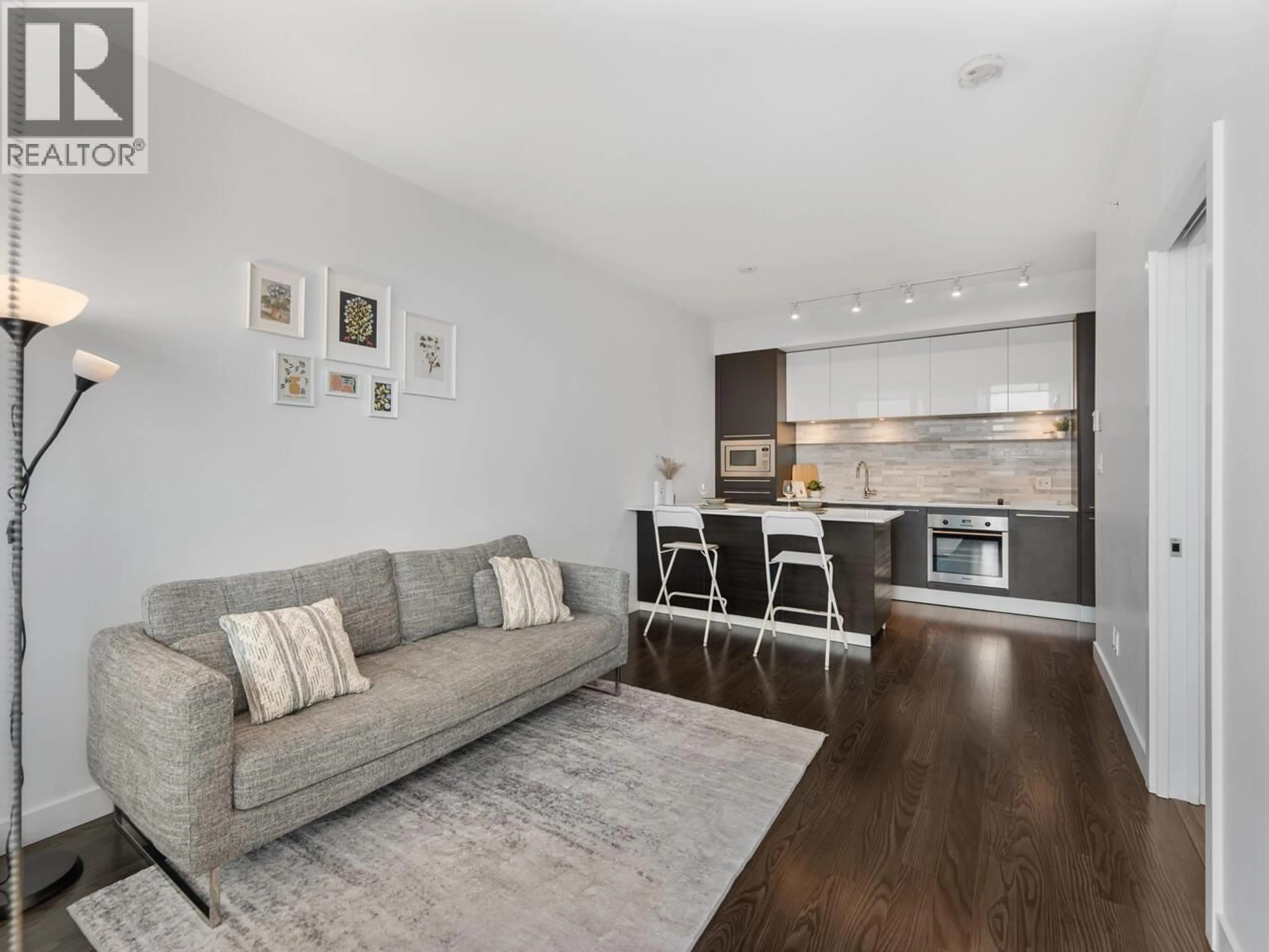 Living room with furniture, wood/laminate floor for 2309 - 8031 NUNAVUT LANE, Vancouver British Columbia V5X0C9