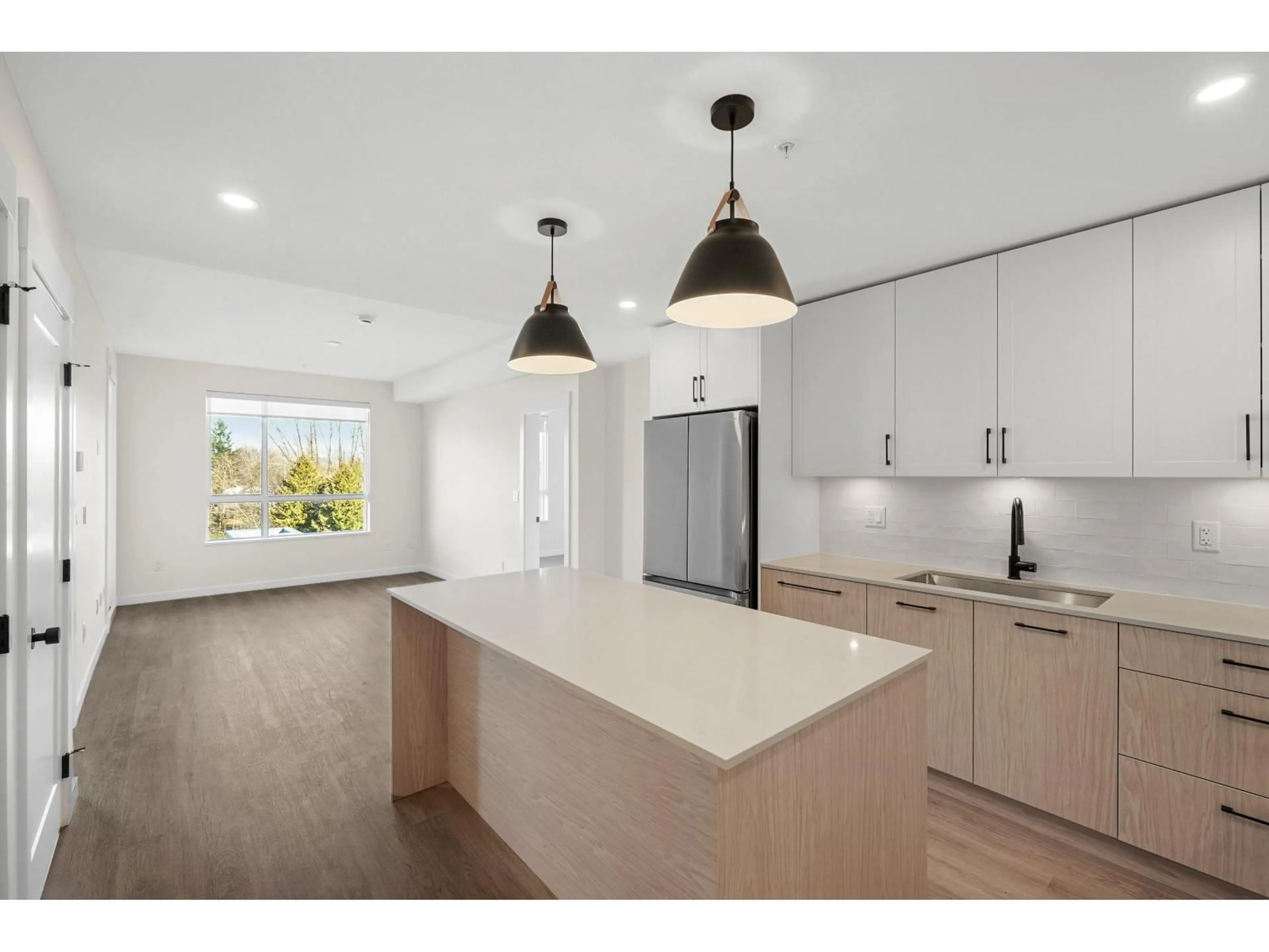 Open concept kitchen, wood/laminate floor for 505 - 27218 ALDERGROVE TOWN CENTRE DRIVE, Langley British Columbia V4W3N7