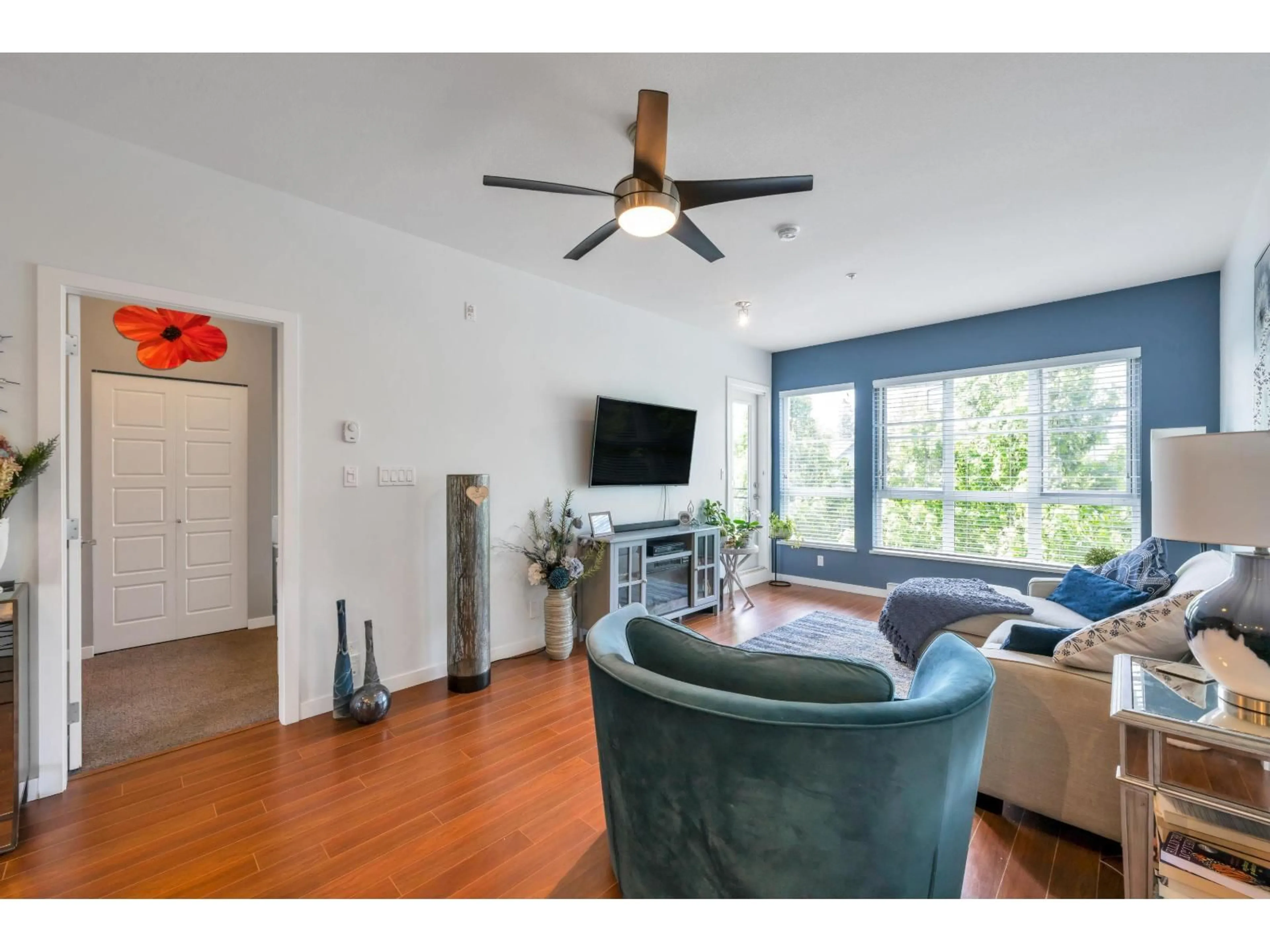 Living room with furniture, wood/laminate floor for 309 - 23215 BILLY BROWN ROAD, Langley British Columbia V1M0B7