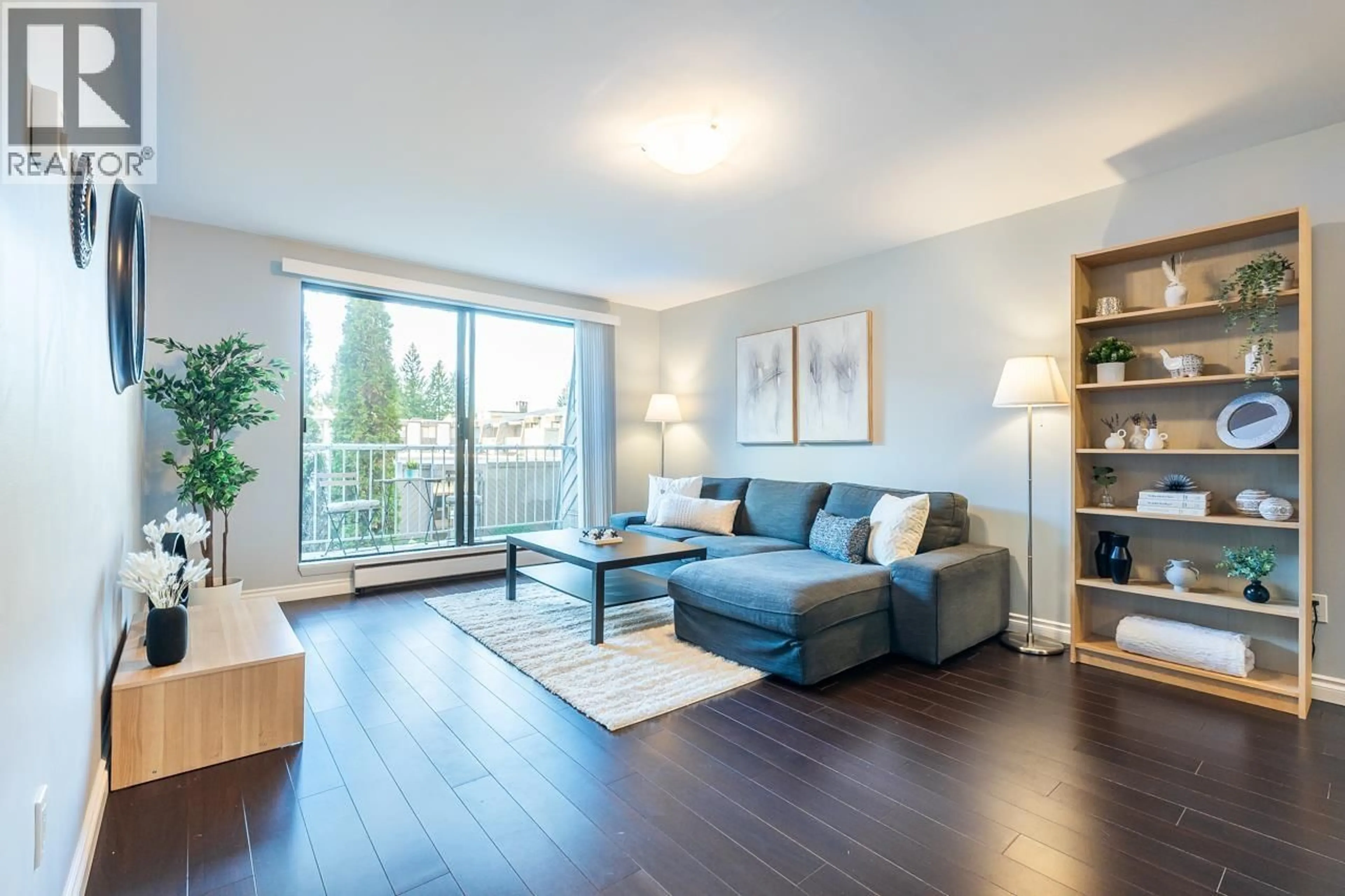 Living room with furniture, wood/laminate floor for 222 - 3921 CARRIGAN COURT, Burnaby British Columbia V3N4J7