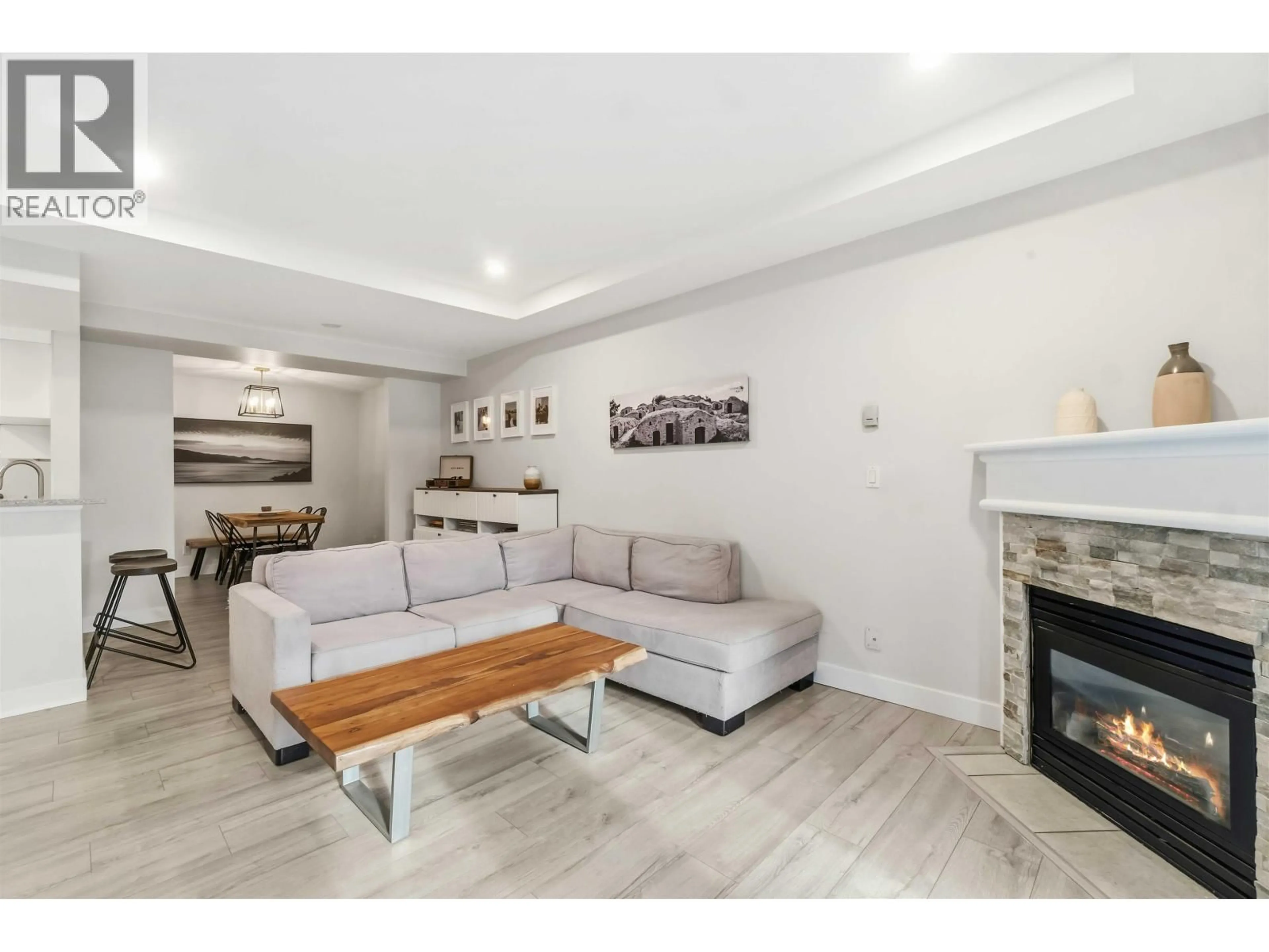 Living room with furniture, wood/laminate floor for 104 - 1423 BRUNETTE AVENUE, Coquitlam British Columbia V3K7A2