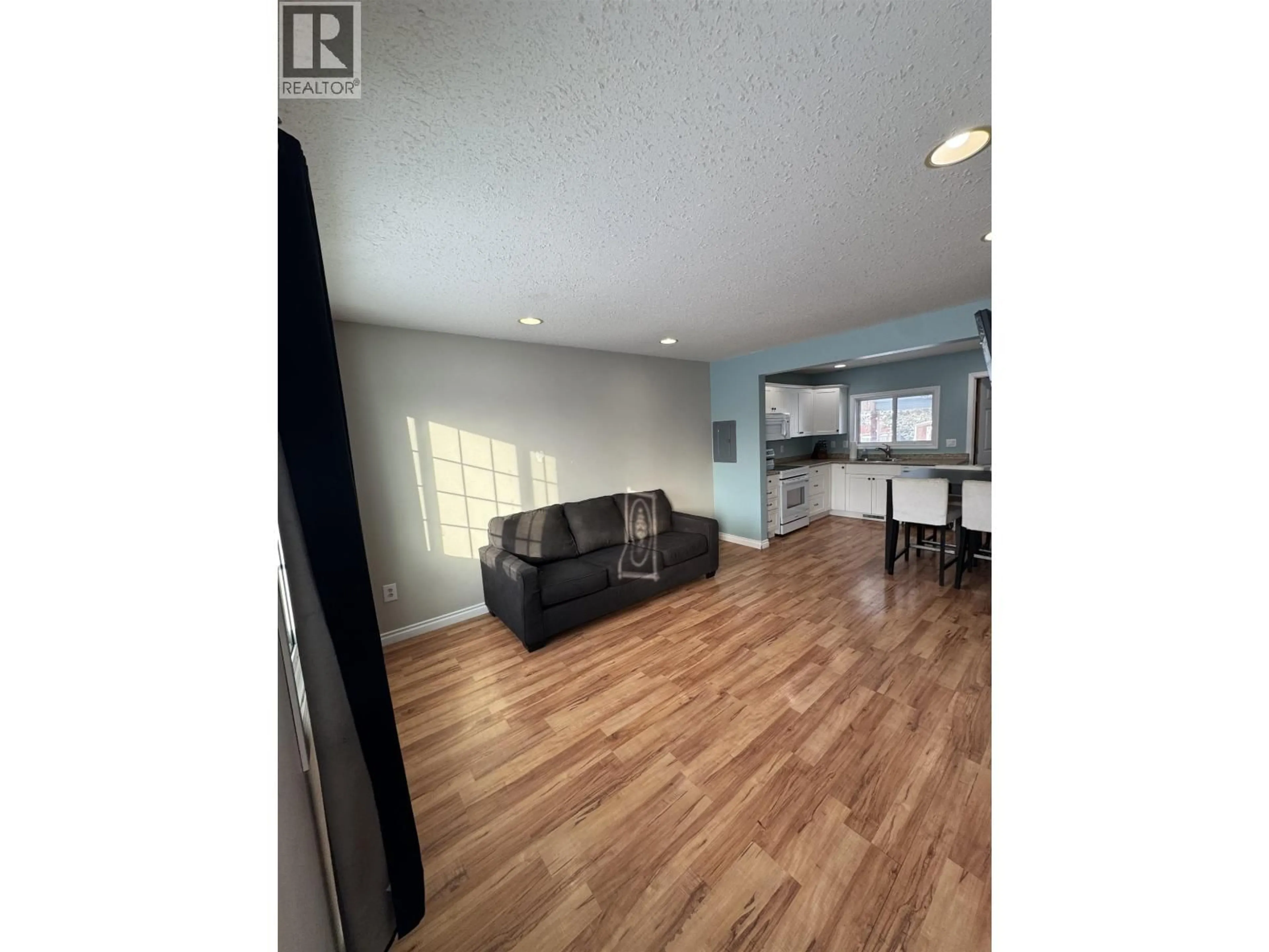 Open concept kitchen, wood/laminate floor for 8320 96 AVENUE, Fort St. John British Columbia V1J1J8