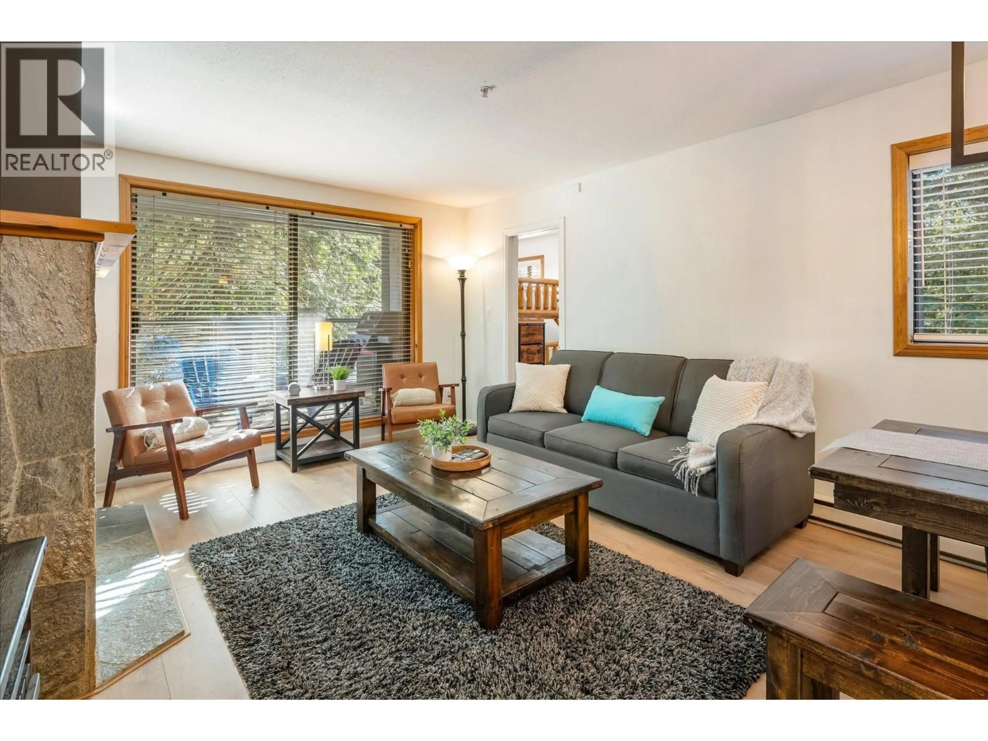 Living room with furniture, wood/laminate floor for 204 - 4821 SPEARHEAD DRIVE, Whistler British Columbia V8E1E8