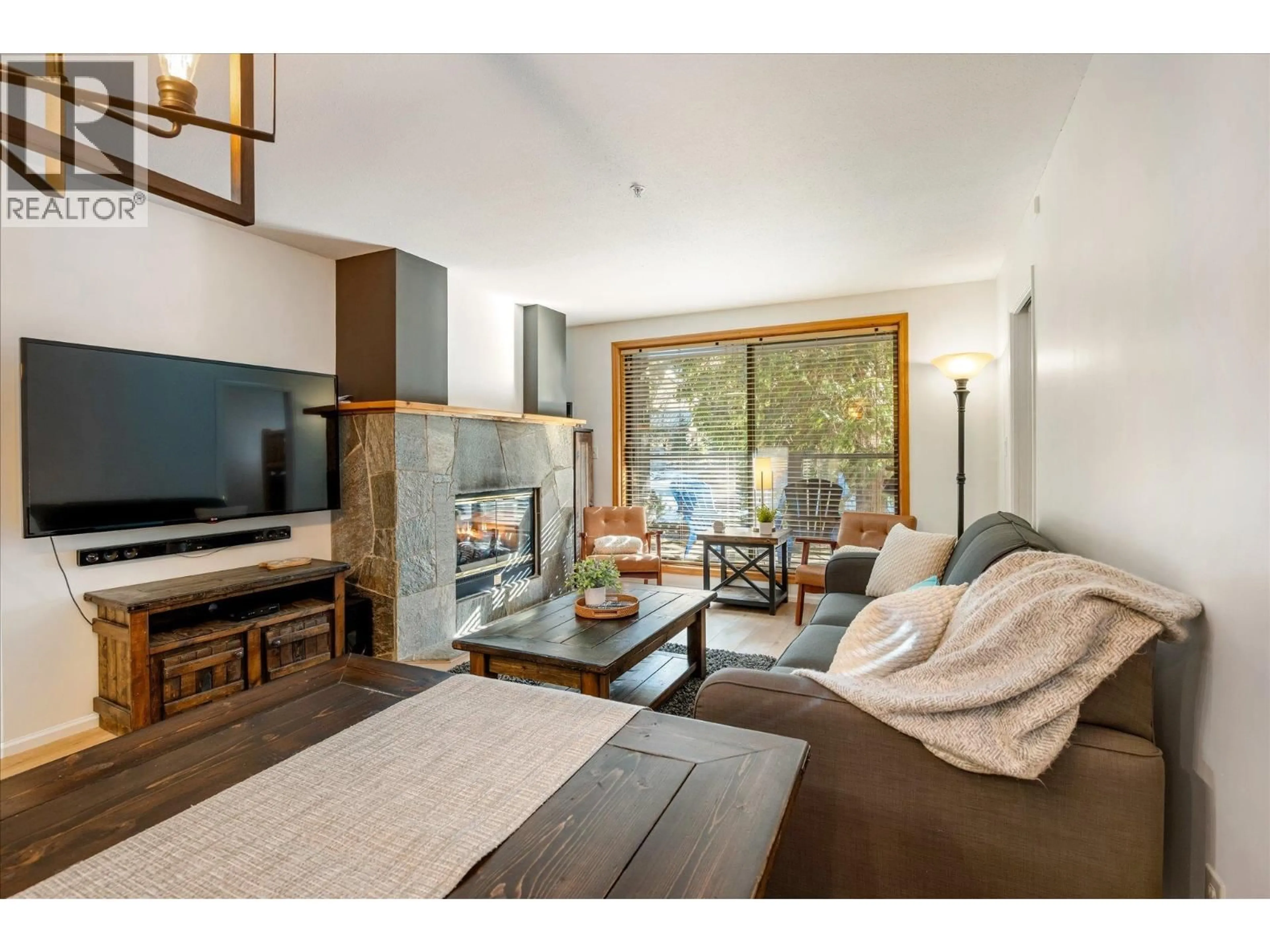 Living room with furniture, wood/laminate floor for 204 - 4821 SPEARHEAD DRIVE, Whistler British Columbia V8E1E8