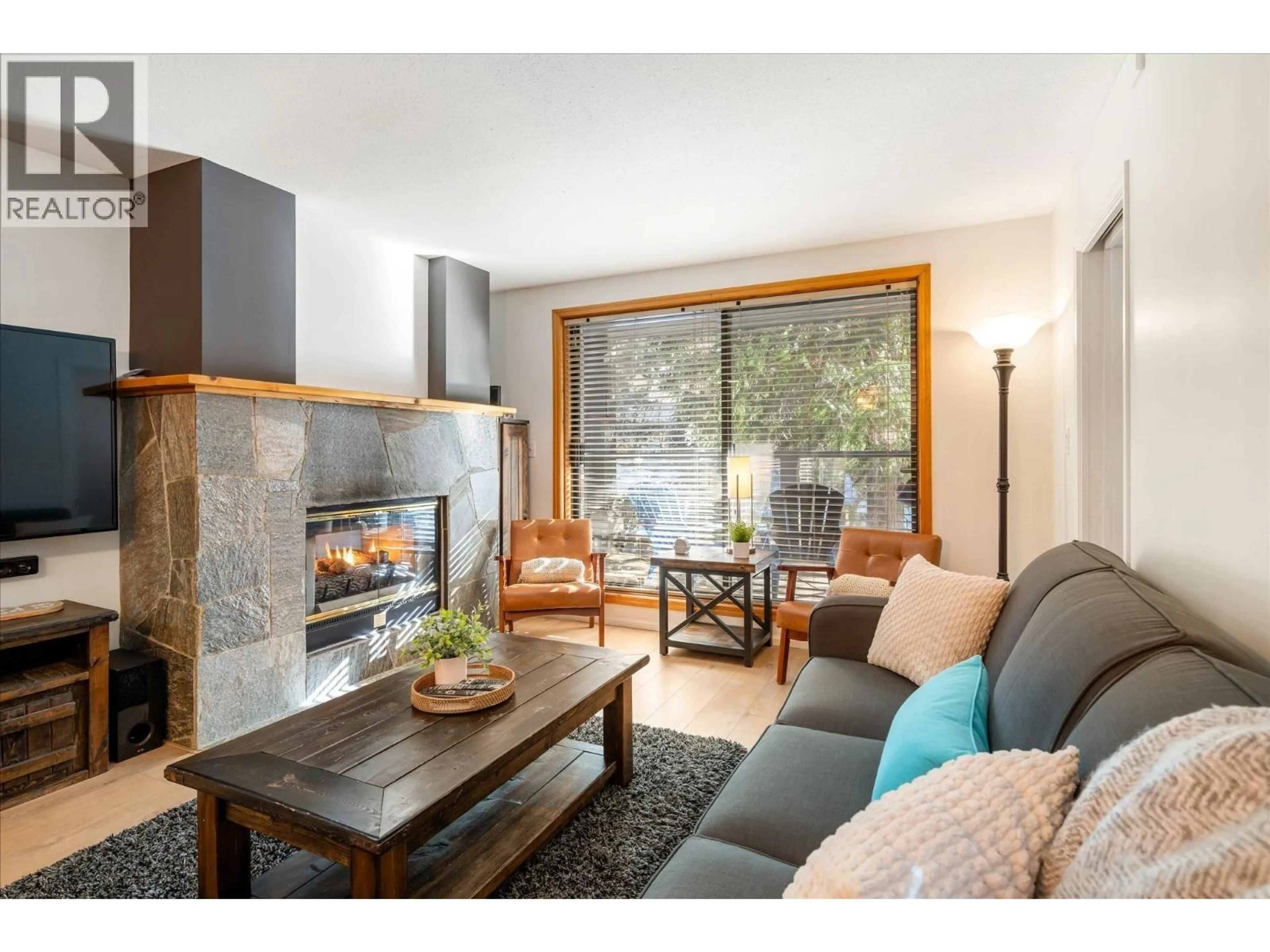 Living room with furniture, wood/laminate floor for 204 - 4821 SPEARHEAD DRIVE, Whistler British Columbia V8E1E8