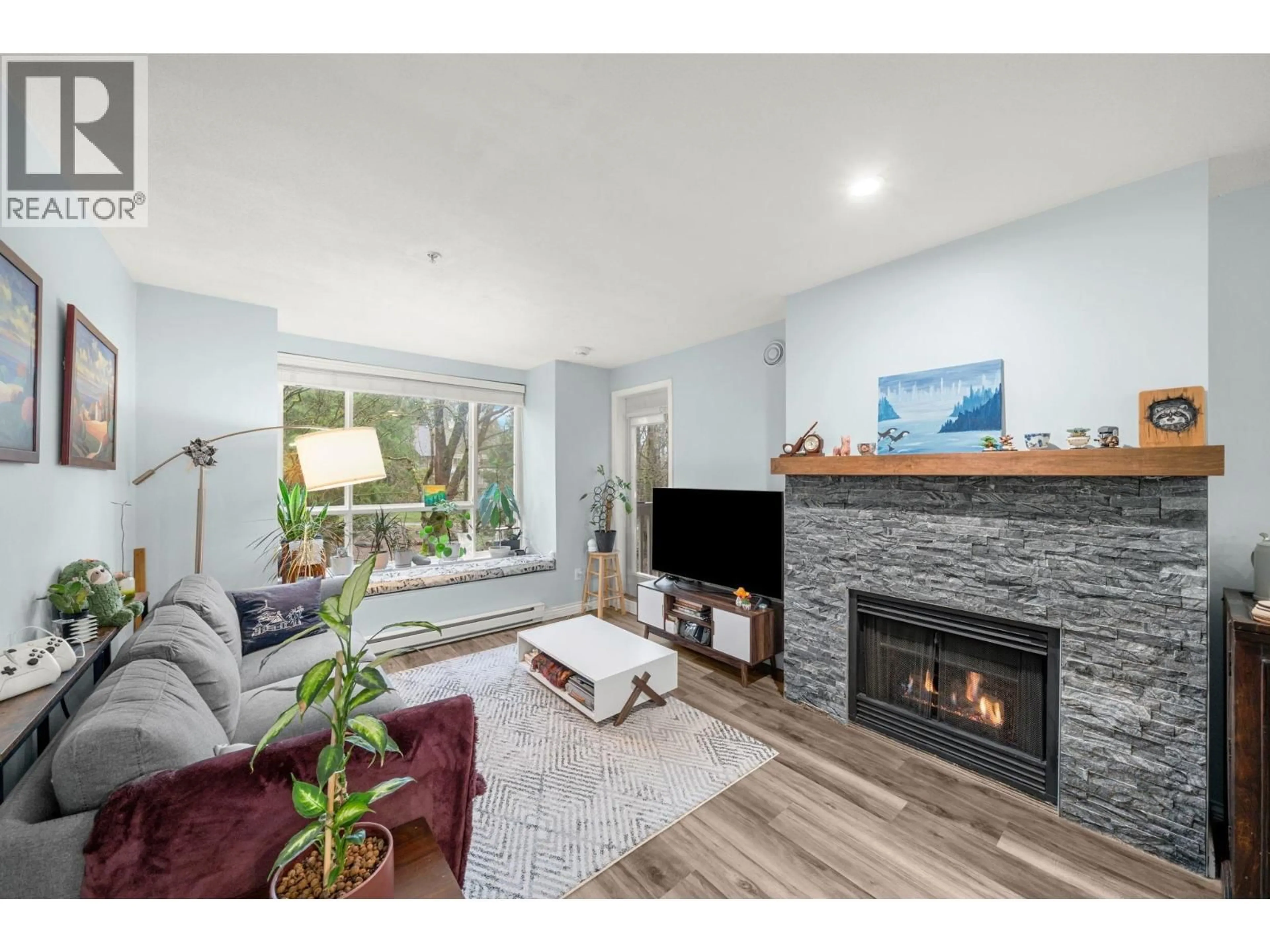 Living room with furniture, wood/laminate floor for 316 - 6833 VILLAGE, Burnaby British Columbia V5E4M1