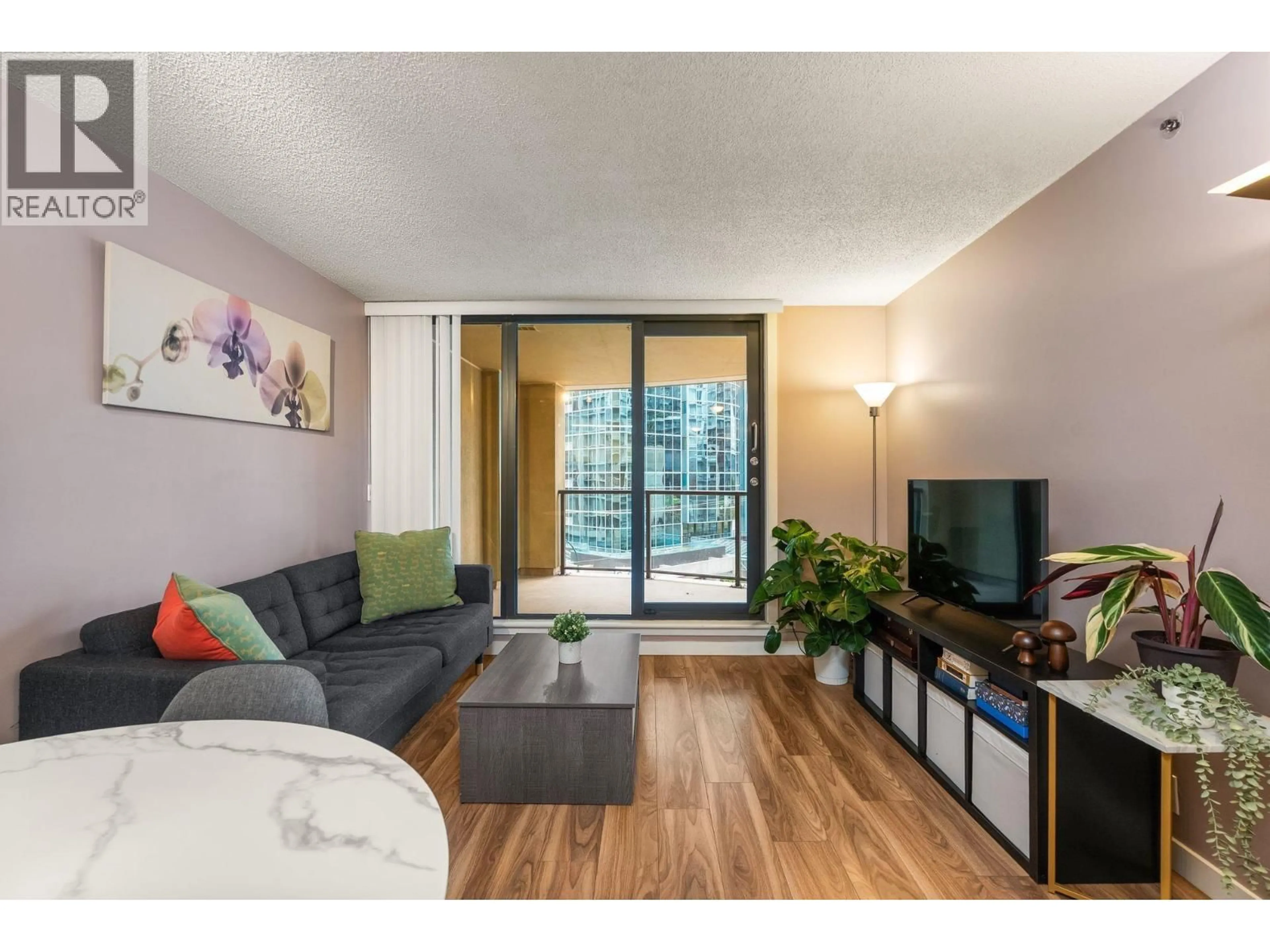 Living room with furniture, wood/laminate floor for 504 - 789 DRAKE STREET, Vancouver British Columbia V6Z2N7