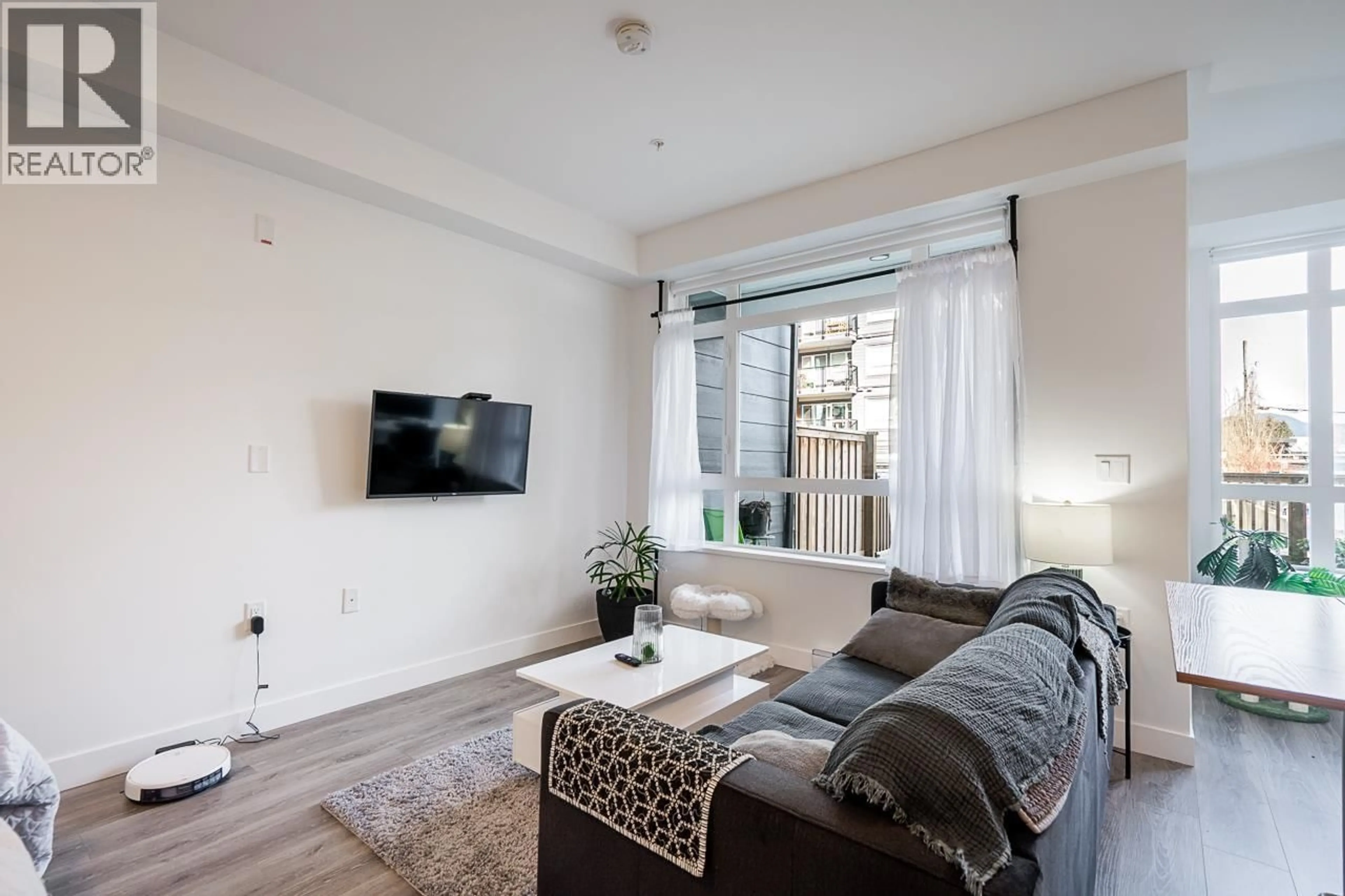 Living room with furniture, wood/laminate floor for 105 - 22575 BROWN AVENUE, Maple Ridge British Columbia V2X6W2