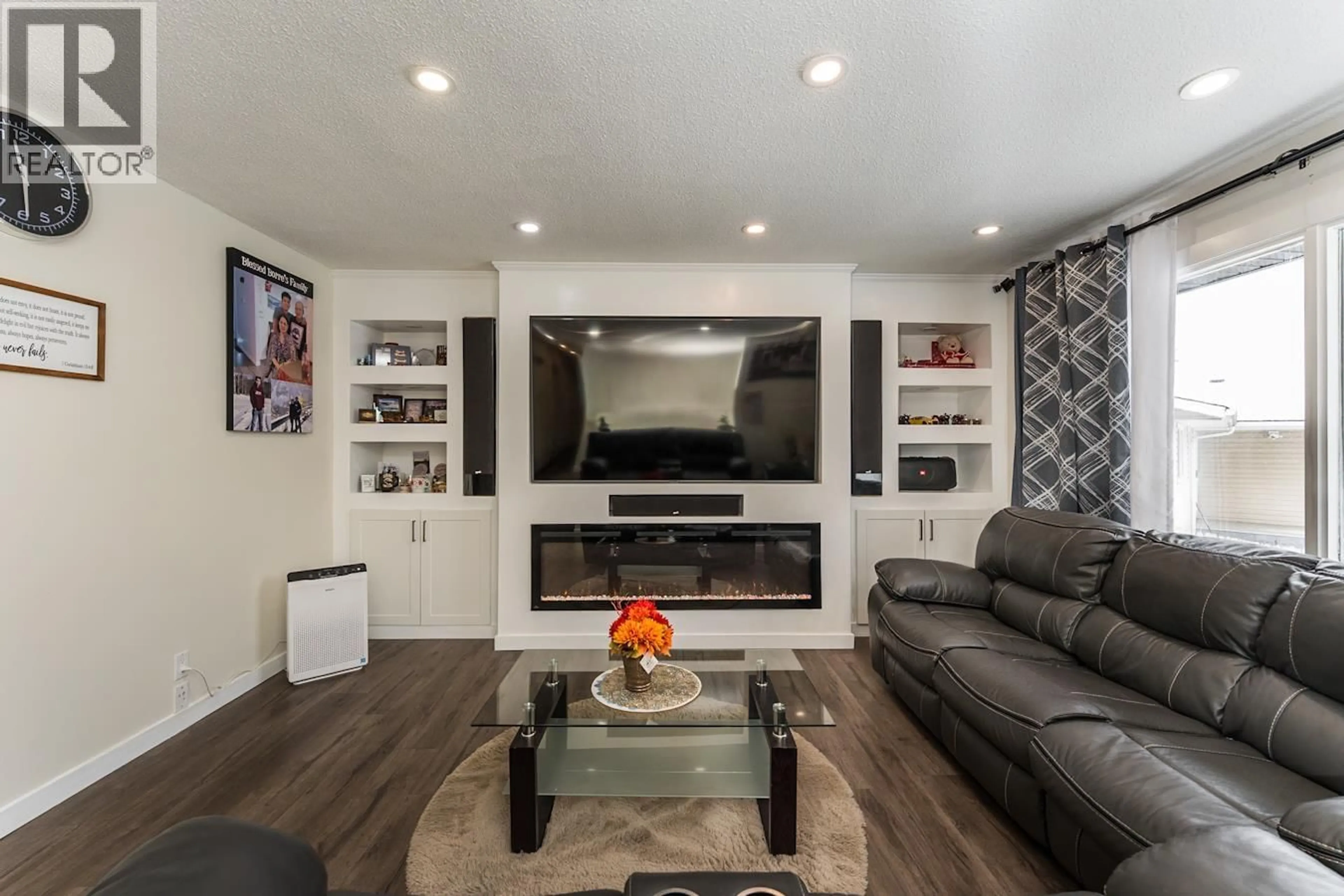 Living room with furniture, wood/laminate floor for 1795 IRWIN STREET, Prince George British Columbia V2M2Y6
