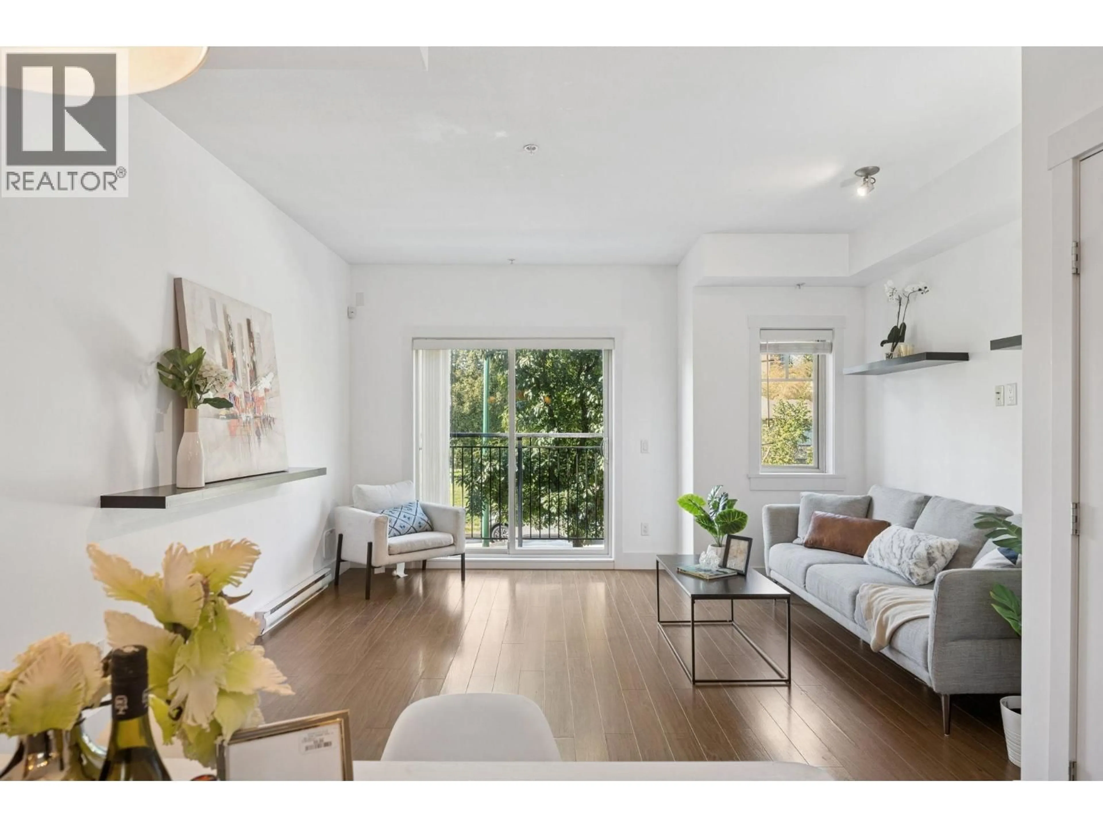 Living room with furniture, wood/laminate floor for 203 - 7168 STRIDE AVENUE, Burnaby British Columbia V3N1T7