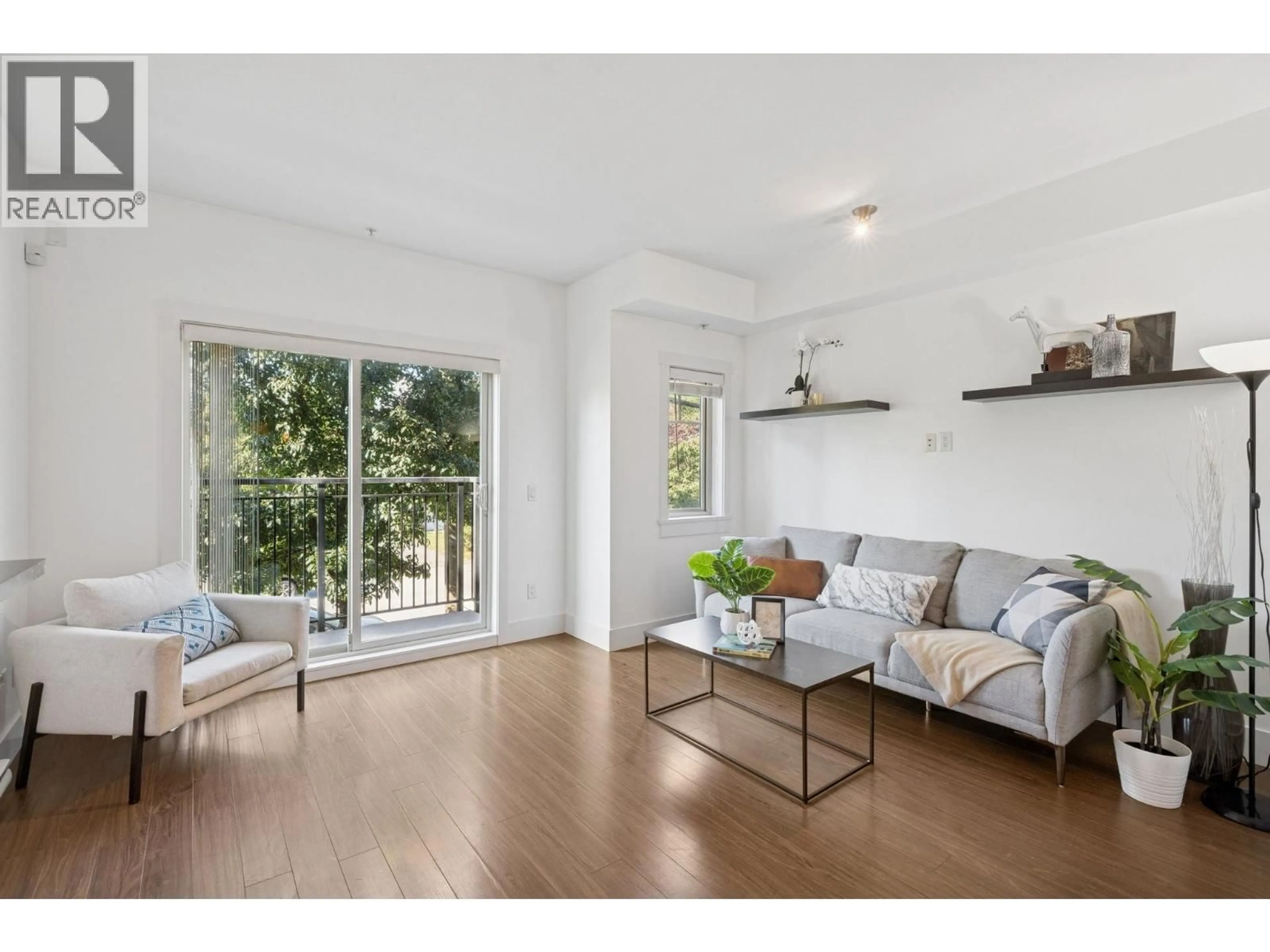 Living room with furniture, wood/laminate floor for 203 - 7168 STRIDE AVENUE, Burnaby British Columbia V3N1T7