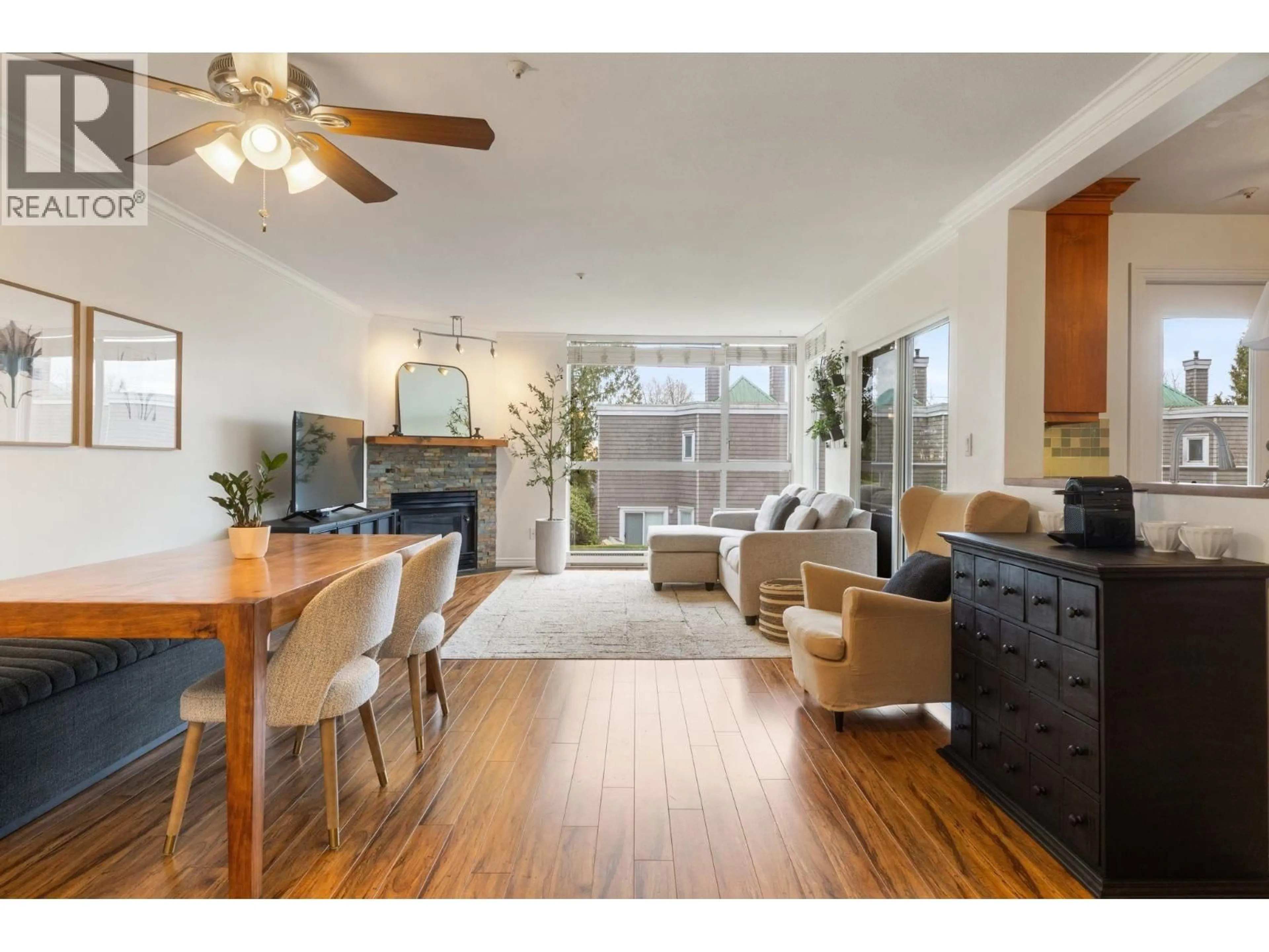 Living room with furniture, wood/laminate floor for 212 - 8450 JELLICOE STREET, Vancouver British Columbia V5S4S9