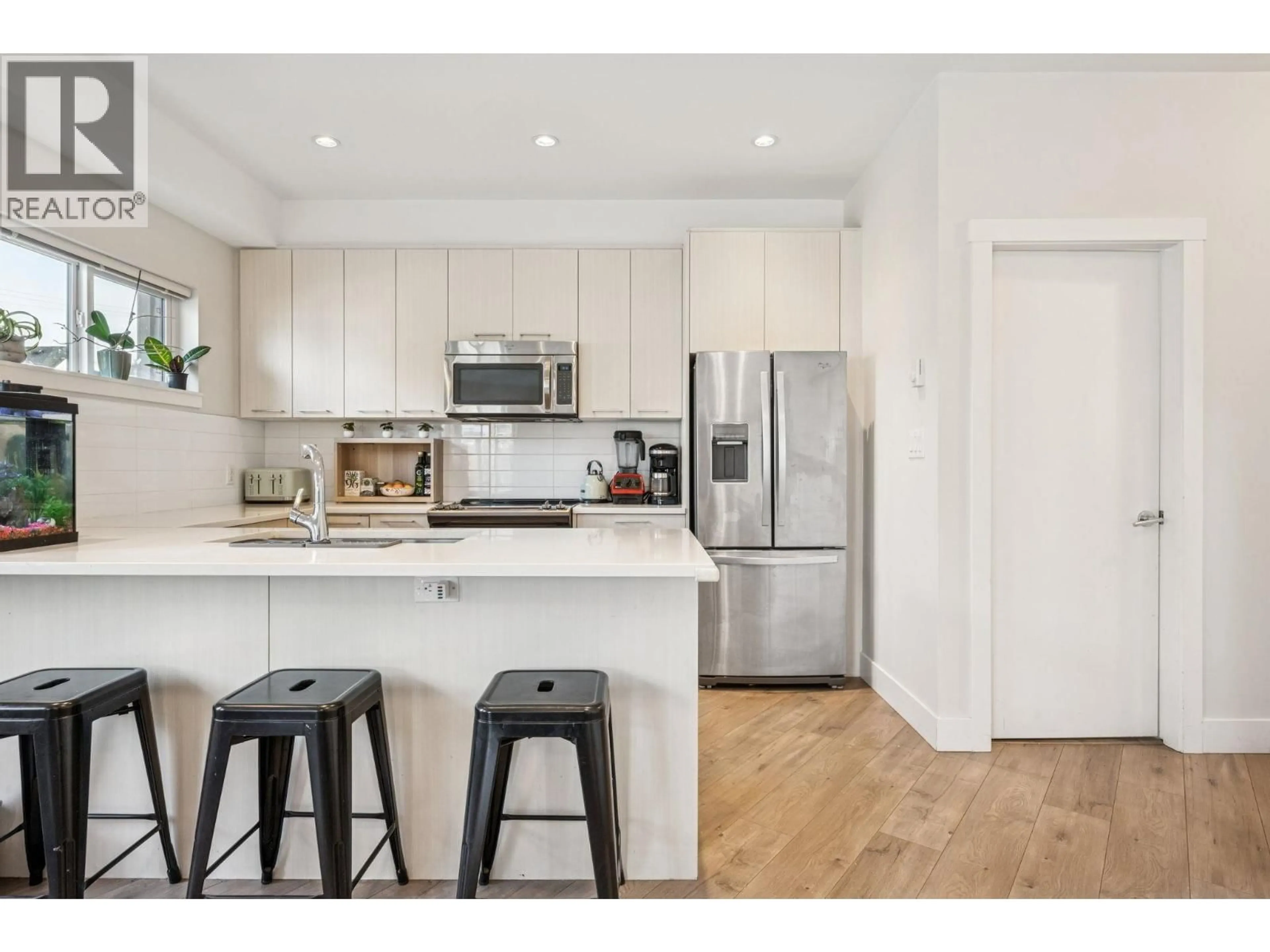 Open concept kitchen, wood/laminate floor for 205 - 7180 BARNET ROAD, Burnaby British Columbia V5A1C8