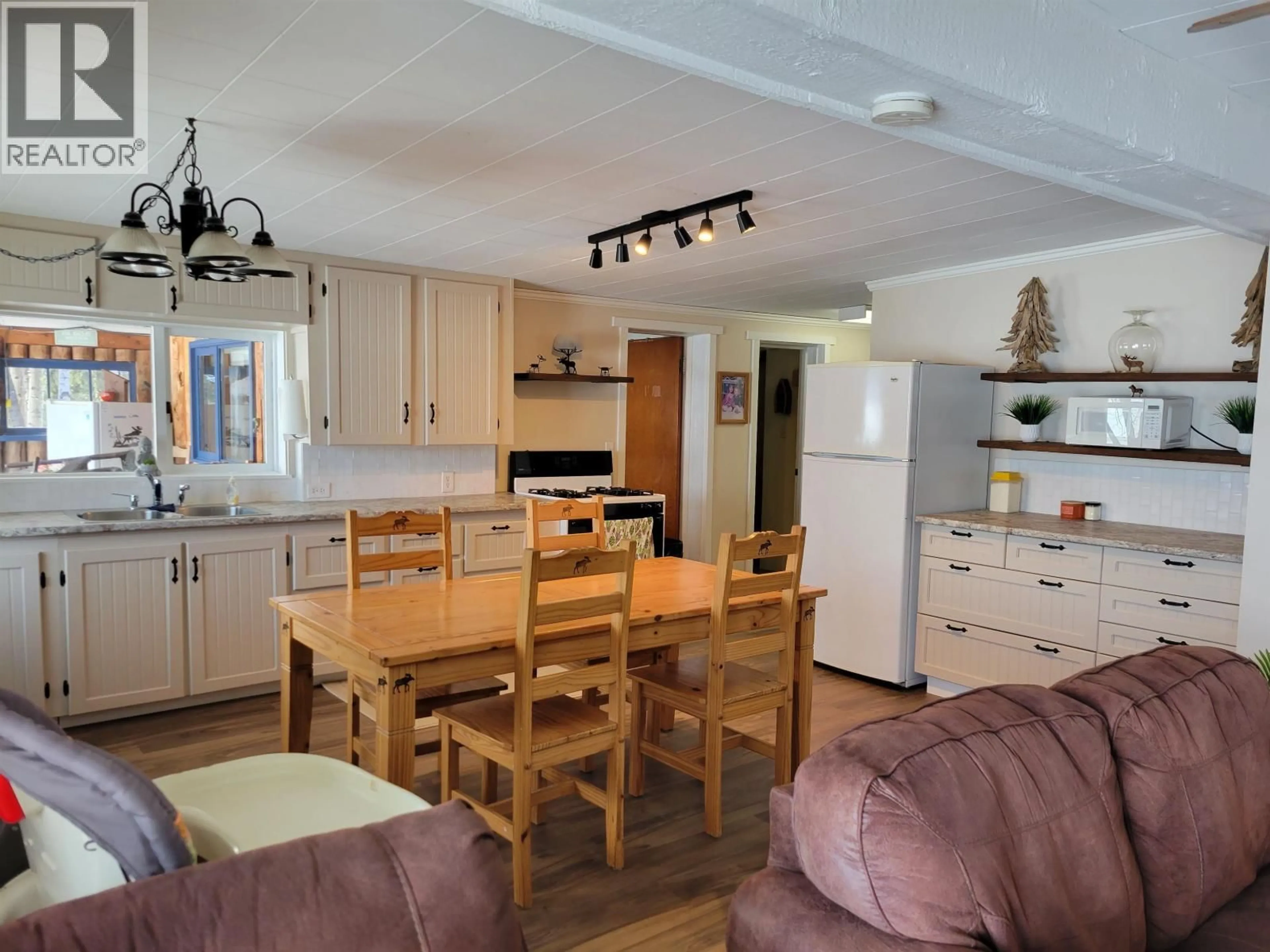 Open concept kitchen, wood/laminate floor for 4780 MANCA PLACE, Fraser Lake British Columbia V0J1S0