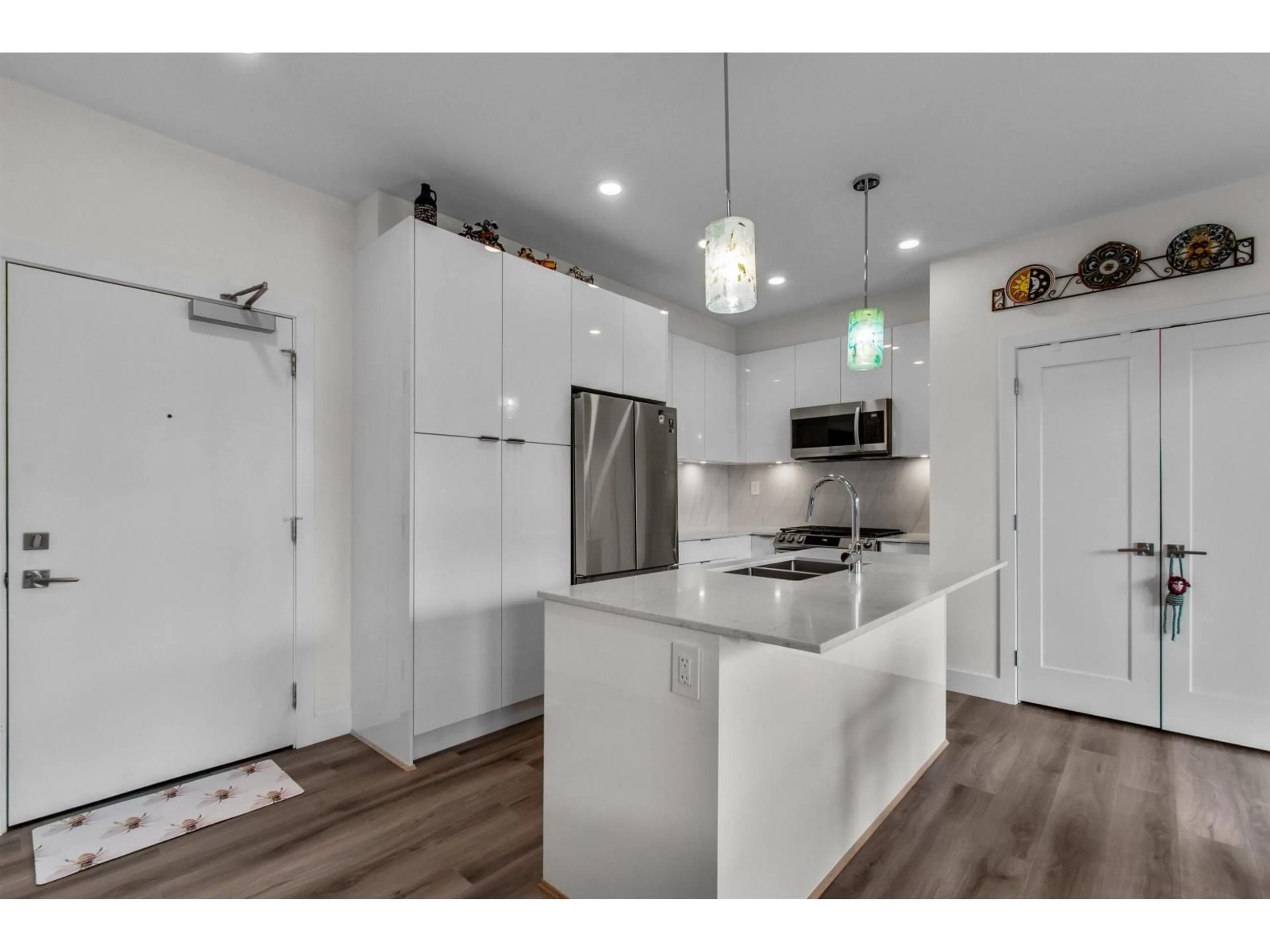 Open concept kitchen, wood/laminate floor for A506 - 8447 202 STREET, Langley British Columbia V2Y2B7