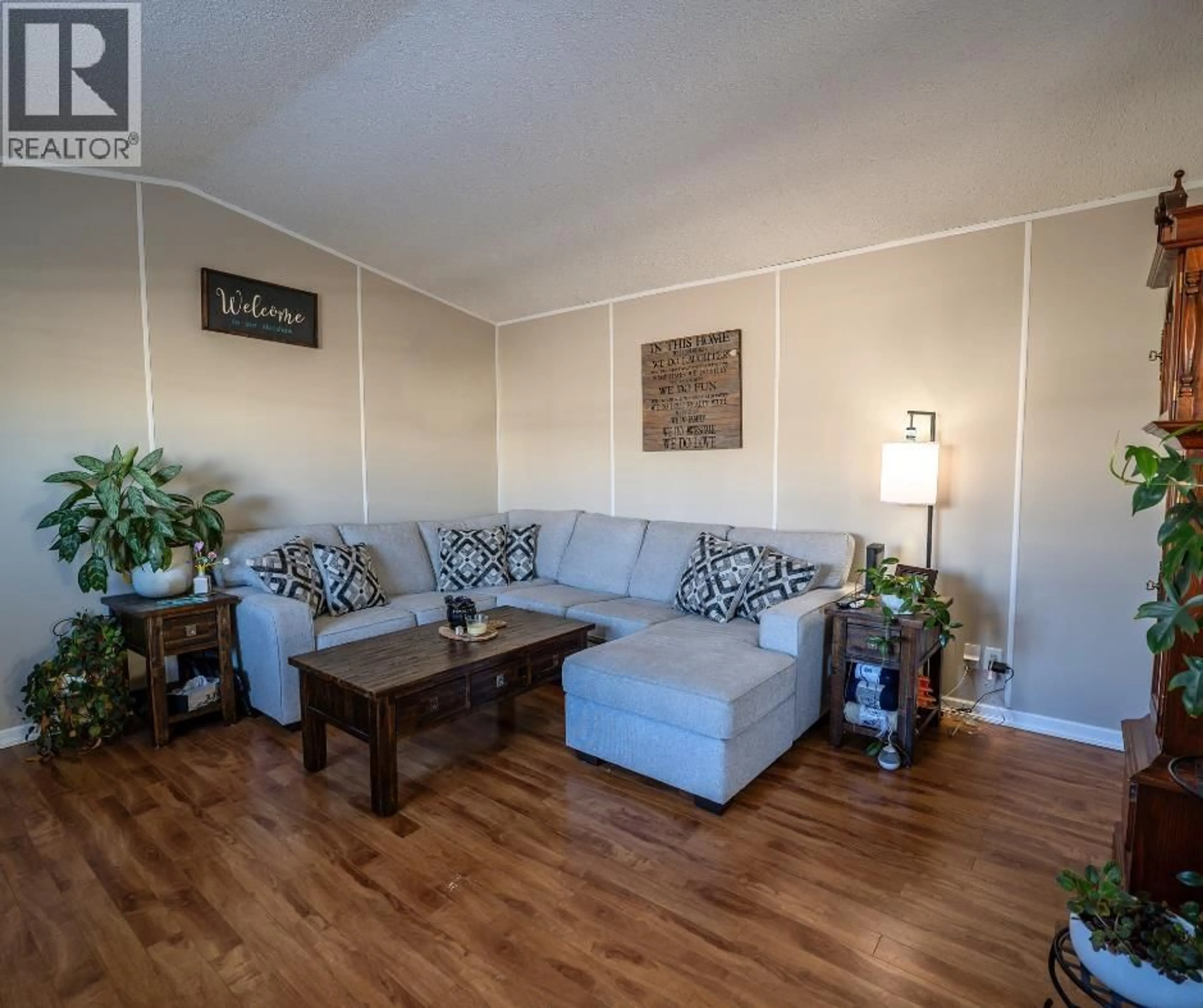 Living room with furniture, wood/laminate floor for 8606 79A STREET, Fort St. John British Columbia V1J0H7