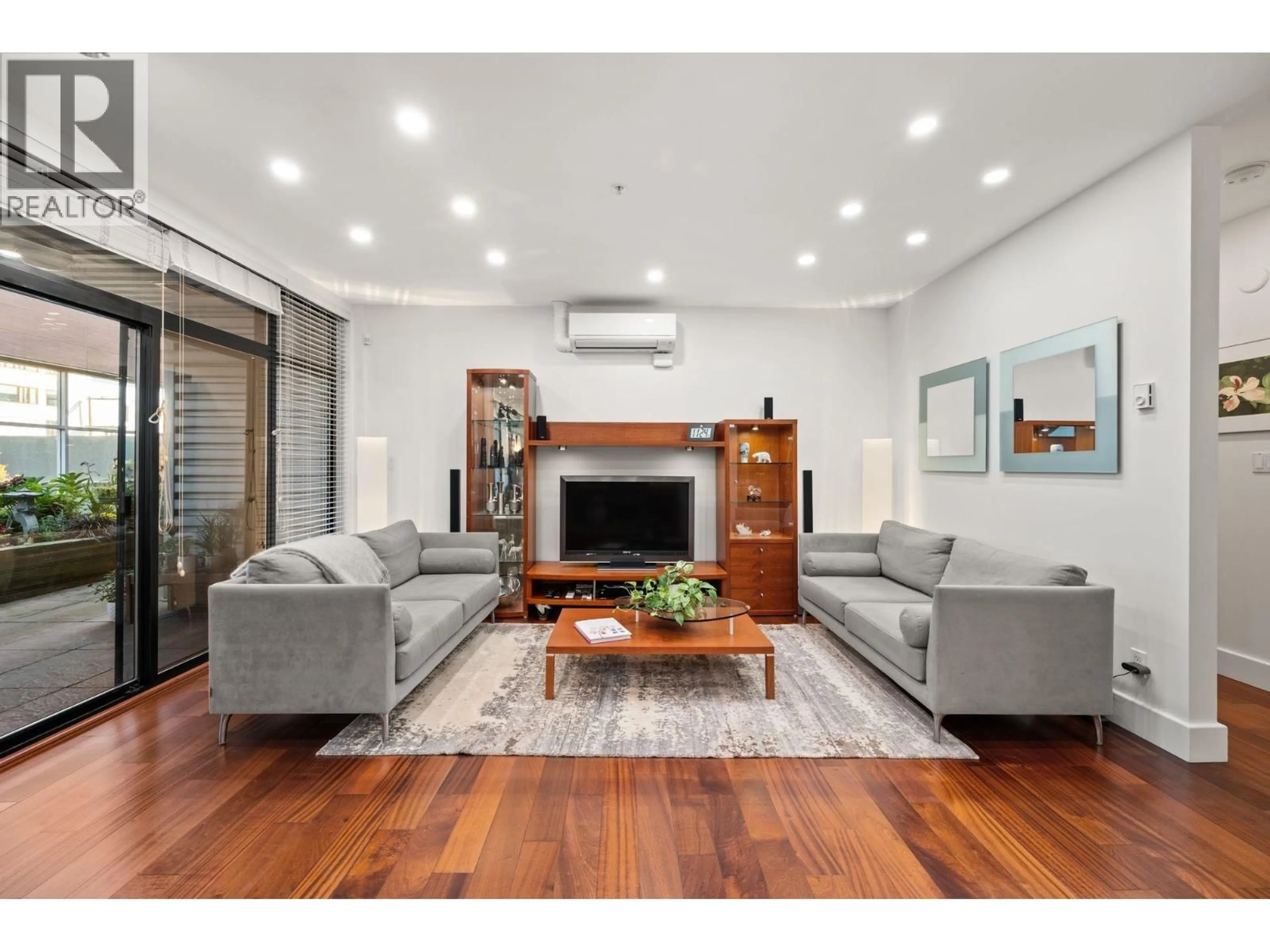 Living room with furniture, wood/laminate floor for 202 - 1750 2ND AVENUE, Vancouver British Columbia V6J1H6