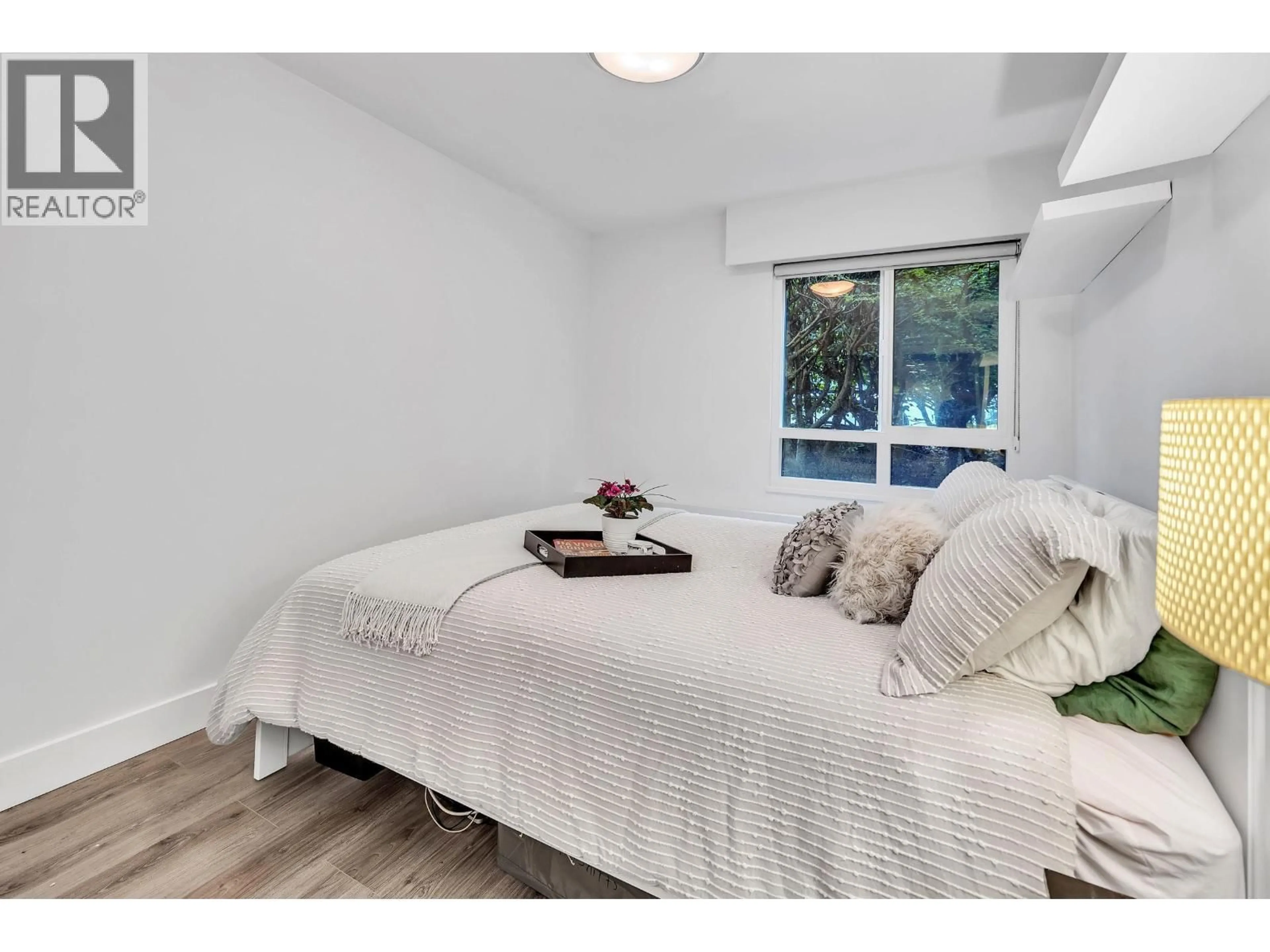 Bedroom with bed, wood/laminate floor for 107 - 215 TEMPLETON DRIVE, Vancouver British Columbia V5L3E3