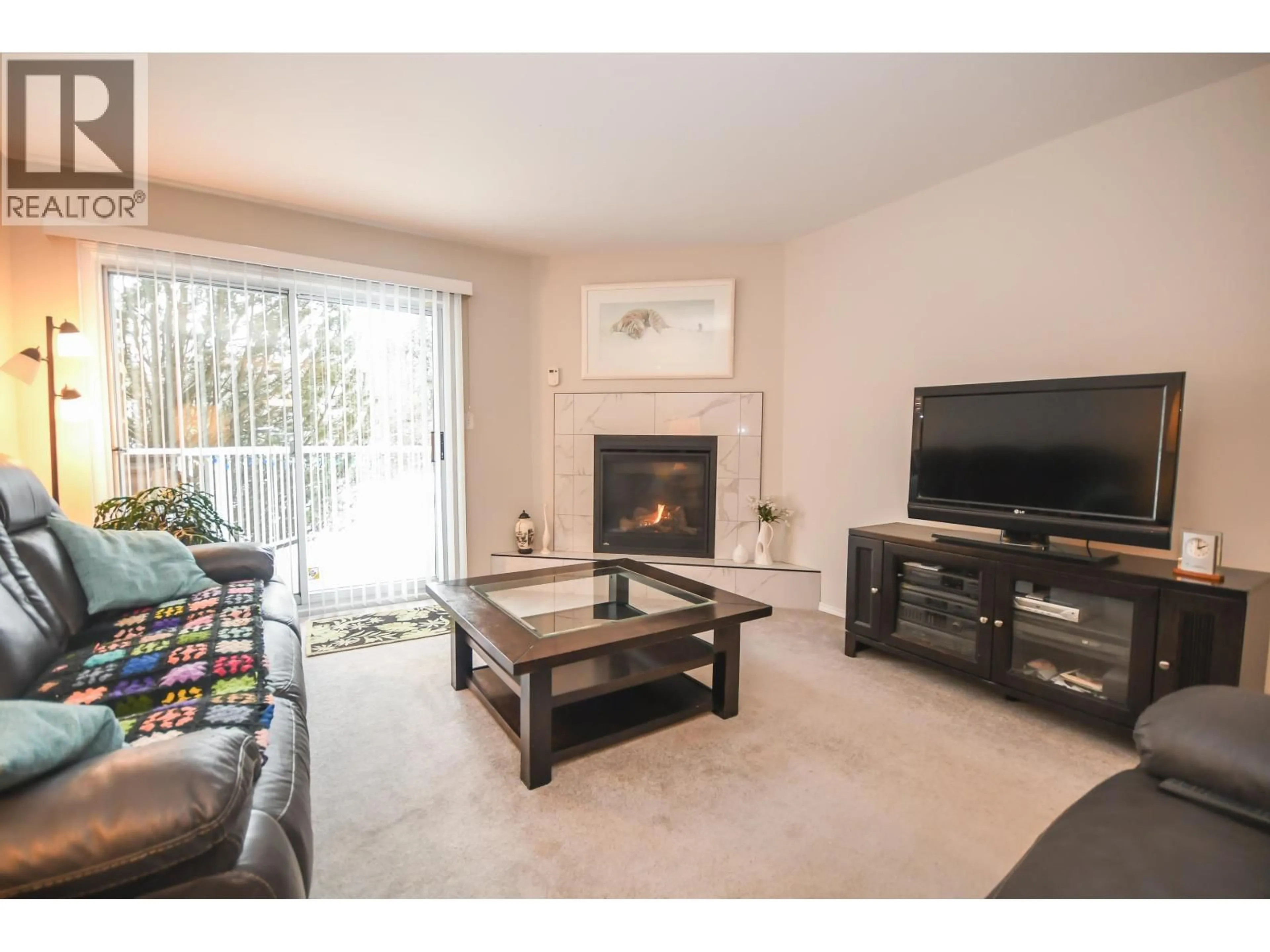 Living room with furniture, wood/laminate floor for 105 - 7255 SOUTHRIDGE AVENUE, Prince George British Columbia V2N4Z3
