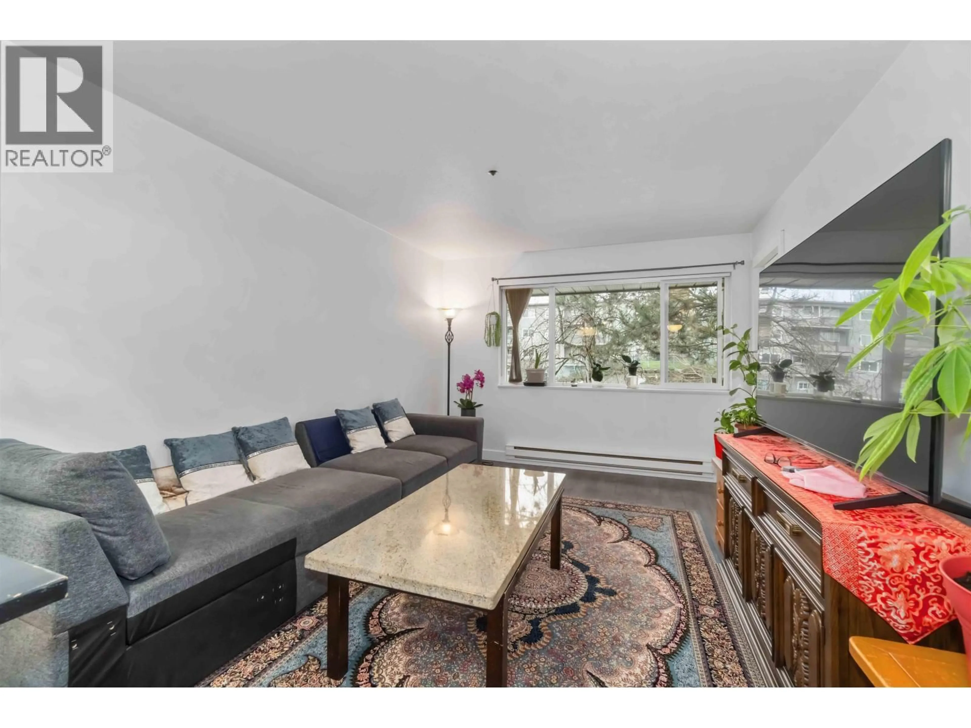 Living room with furniture, wood/laminate floor for 502 - 1310 CARIBOO STREET, New Westminster British Columbia V3M1X2