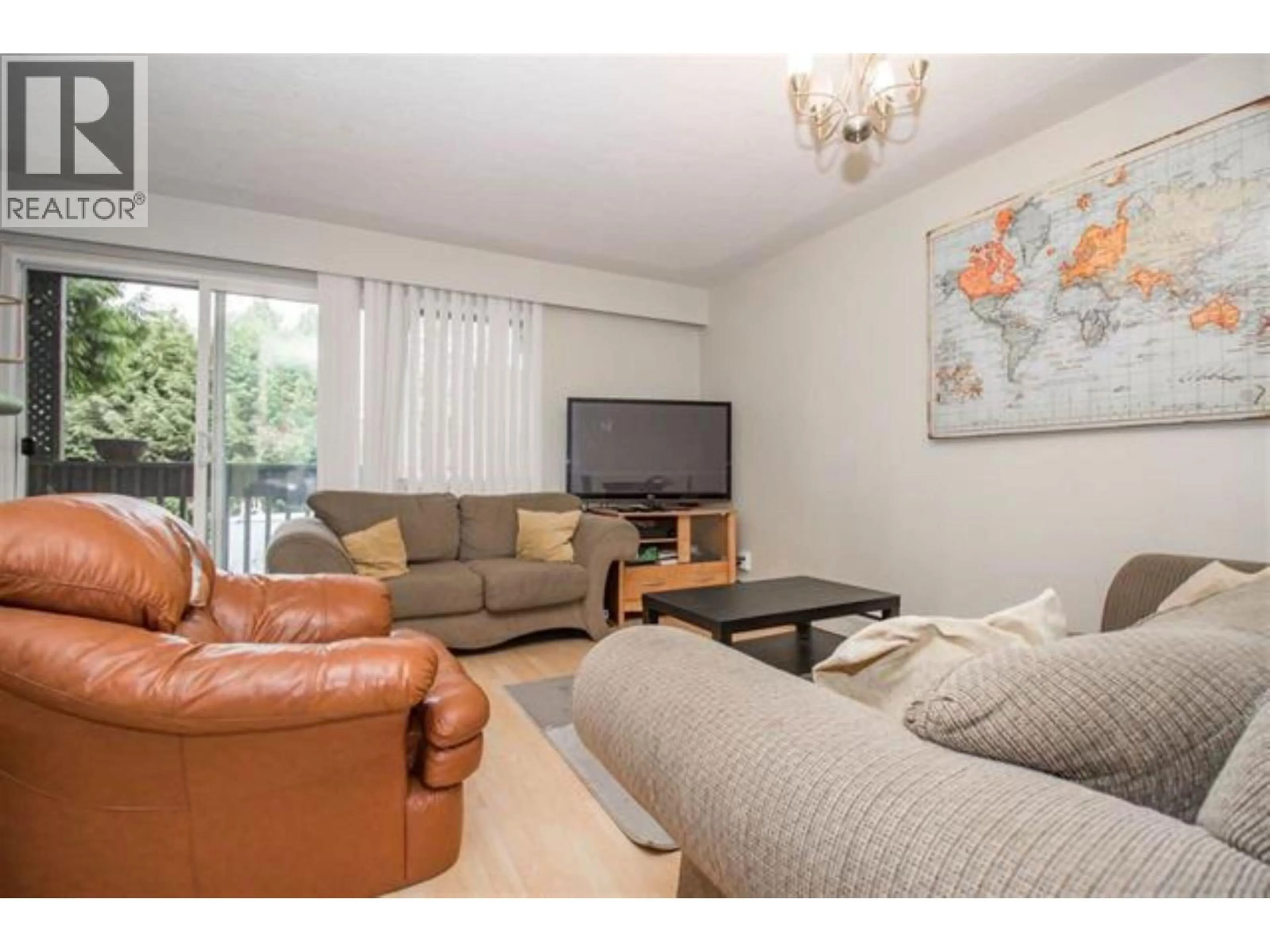 Living room with furniture, wood/laminate floor for 102 - 5770 HASTINGS STREET, Burnaby British Columbia V5B1R6