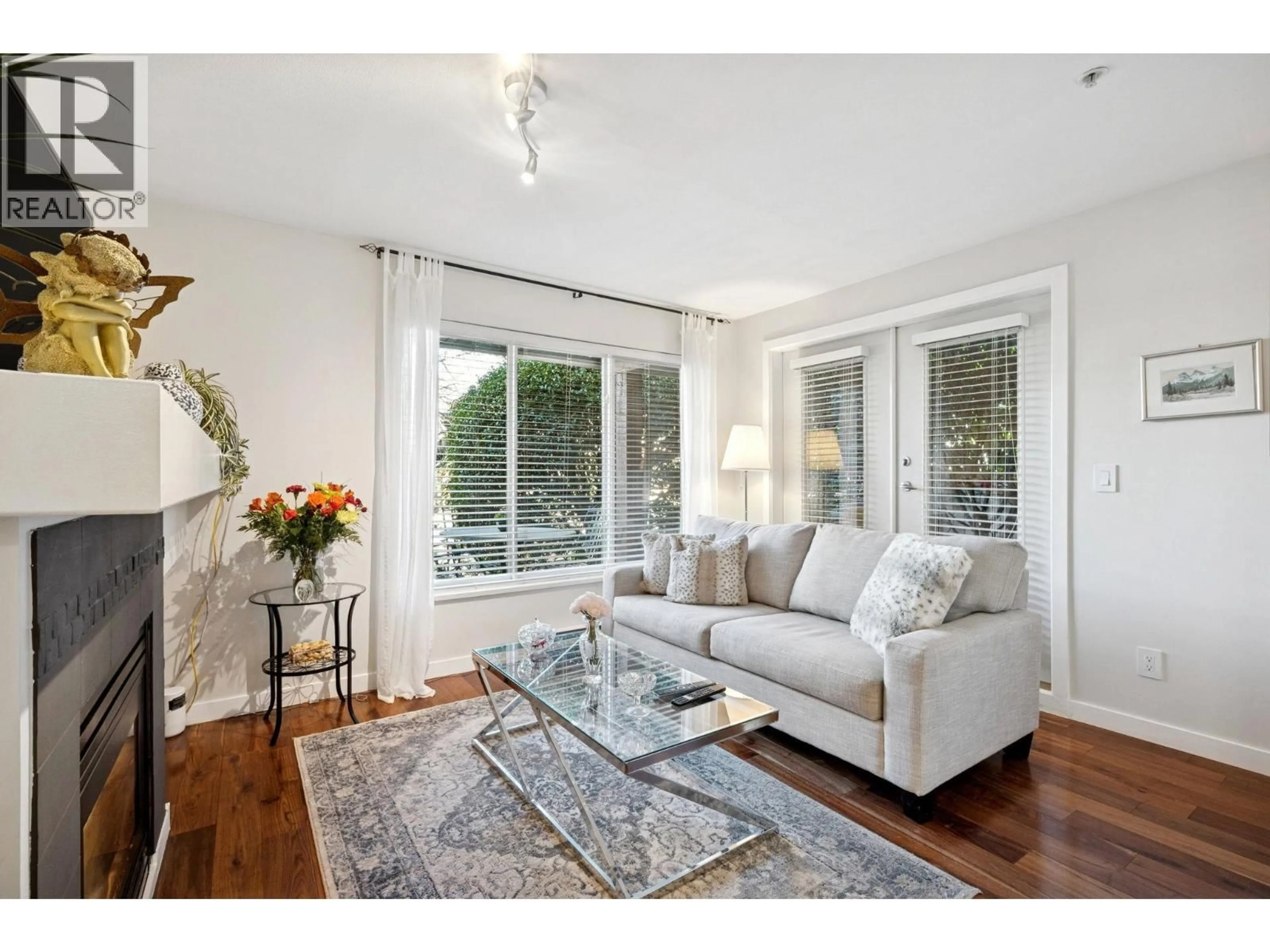 Living room with furniture, wood/laminate floor for 104 - 5700 ANDREWS ROAD, Richmond British Columbia V7E6N7