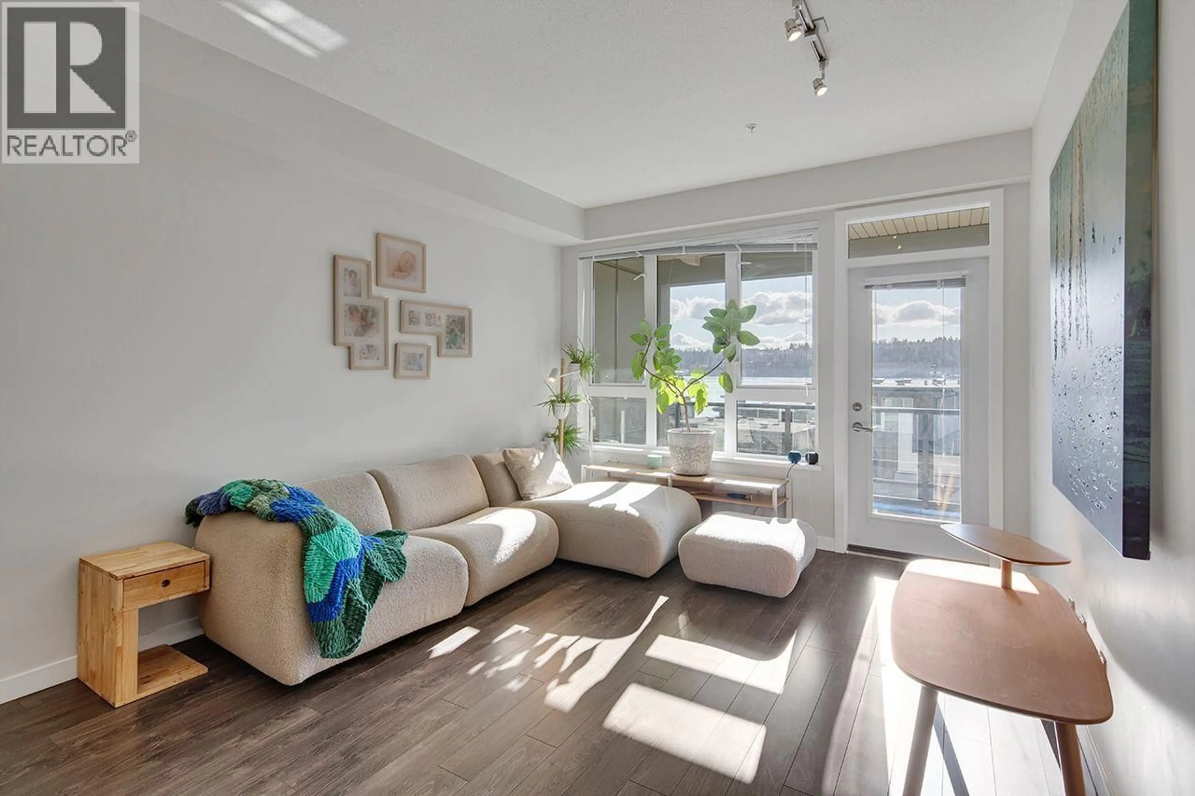 Living room with furniture, wood/laminate floor for 207 - 3825 CATES LANDING WAY, North Vancouver British Columbia V7G0A6