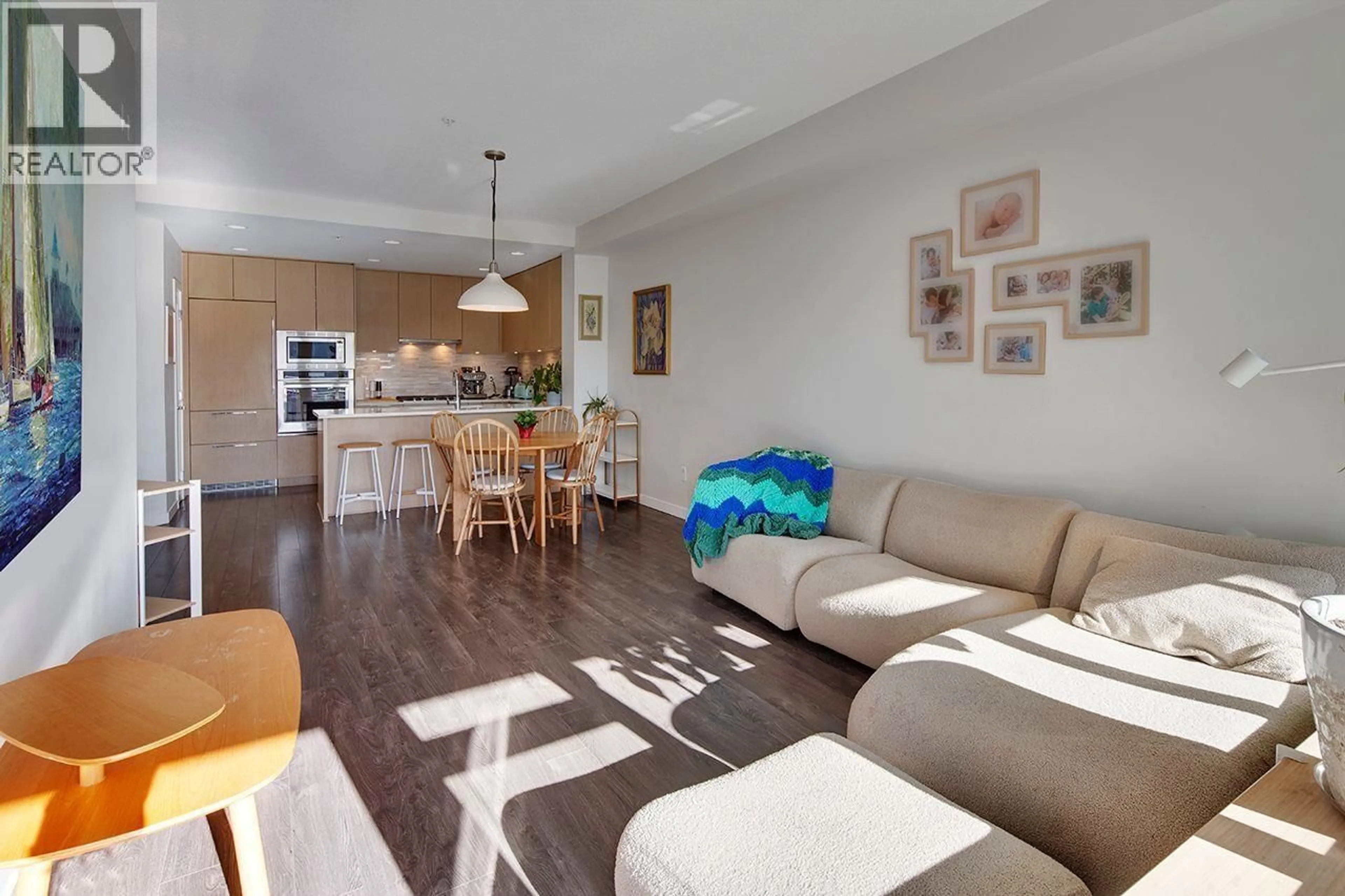 Living room with furniture, wood/laminate floor for 207 - 3825 CATES LANDING WAY, North Vancouver British Columbia V7G0A6