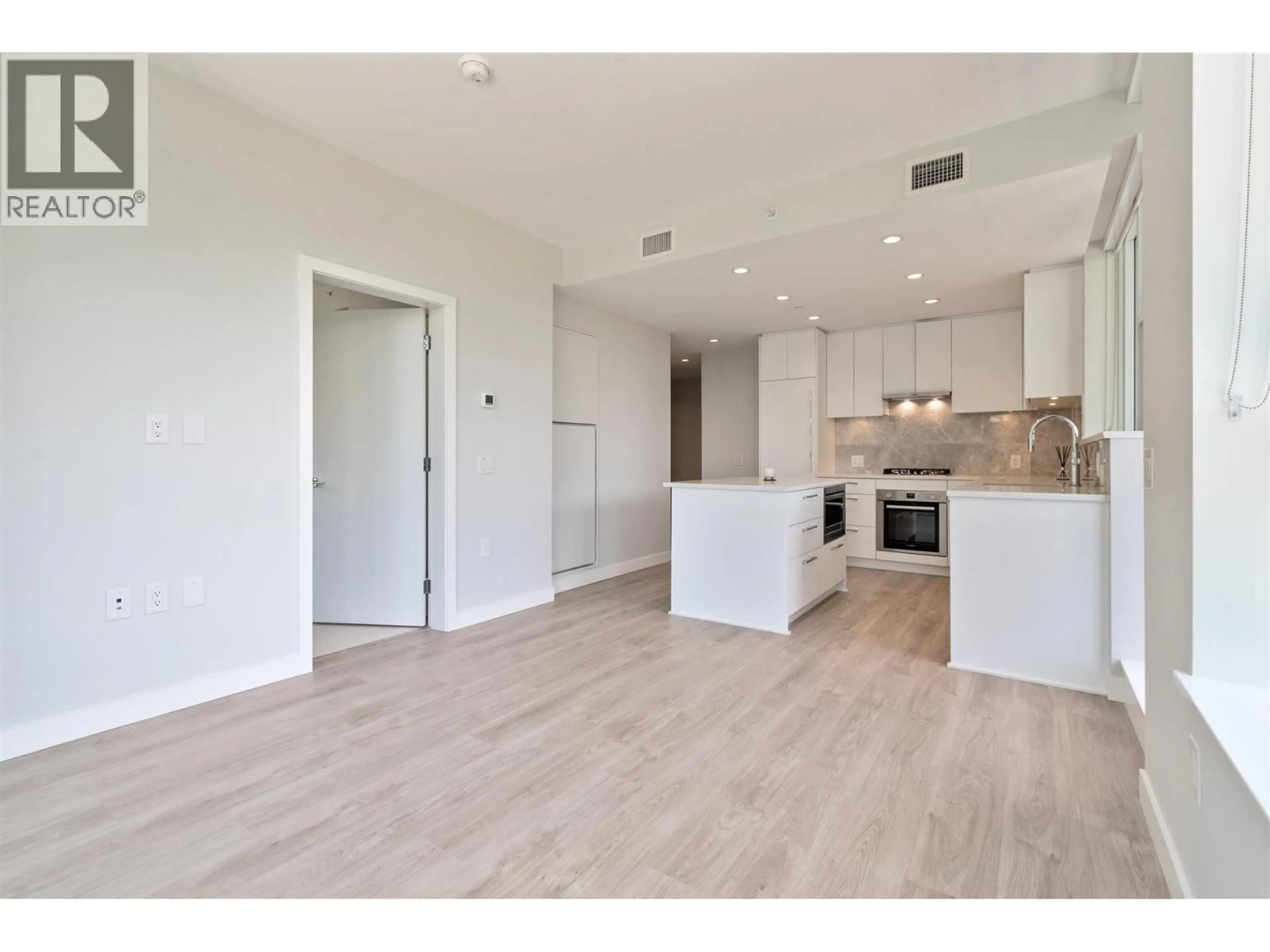 Open concept kitchen, wood/laminate floor for 504 - 5380 CROOKED BRANCH ROAD, Vancouver British Columbia V6T0E5