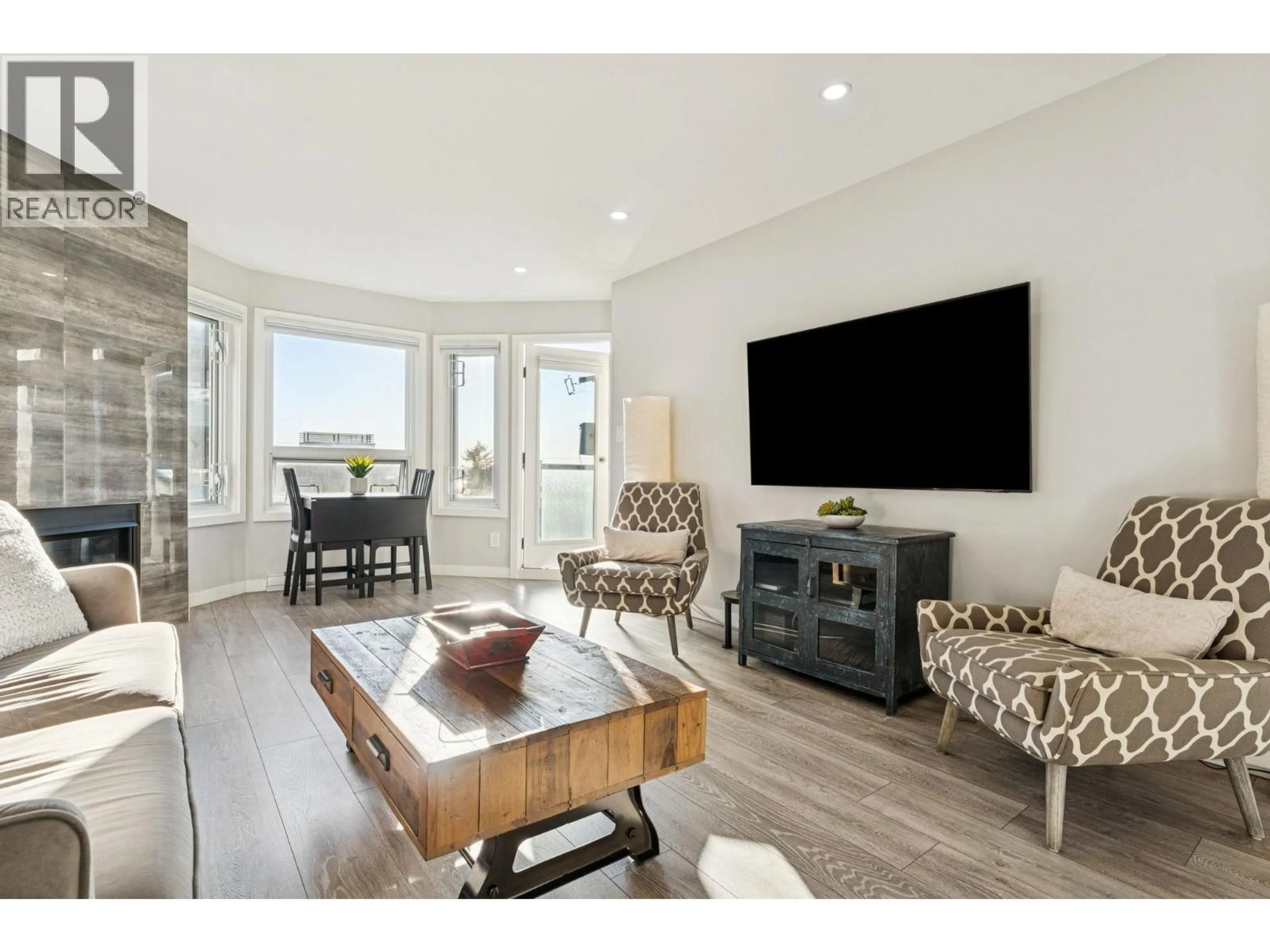 Living room with furniture, wood/laminate floor for 305 - 175 4TH STREET, North Vancouver British Columbia V7M1H6