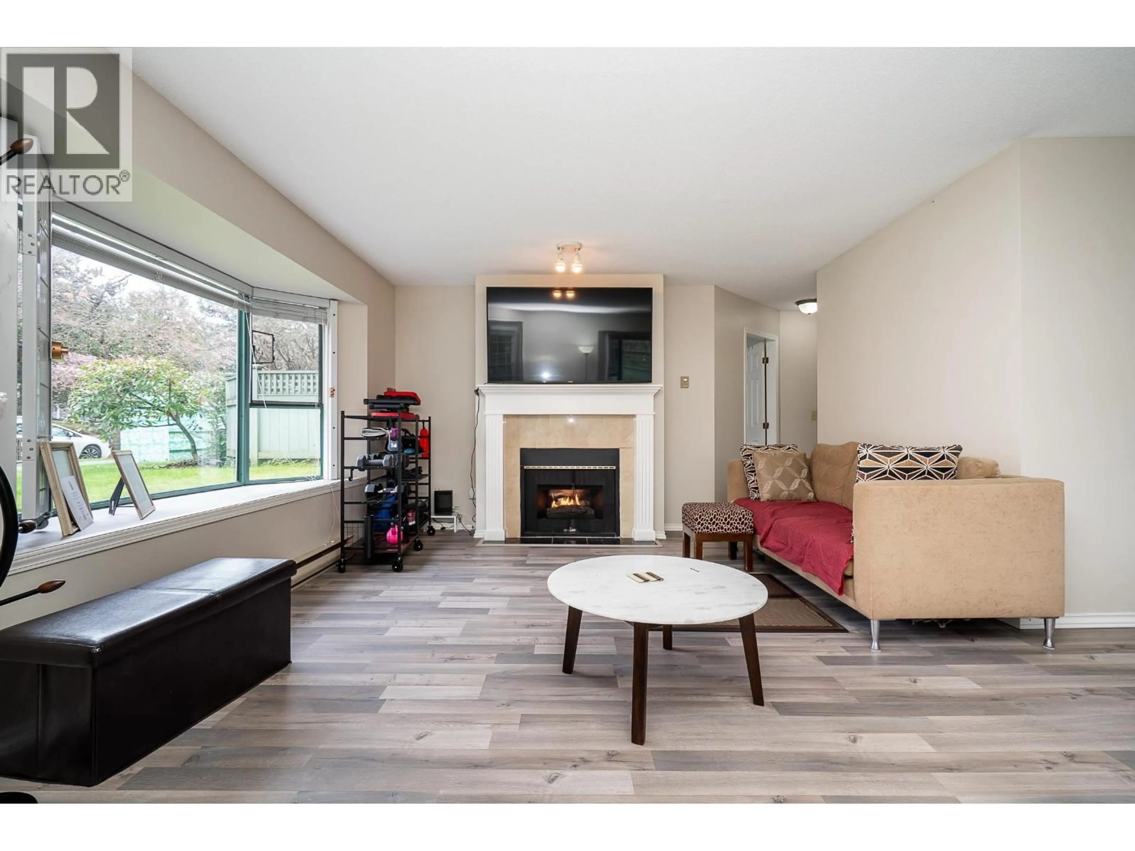 Living room with furniture, wood/laminate floor for 109 - 5250 VICTORY STREET, Burnaby British Columbia V5J5H2