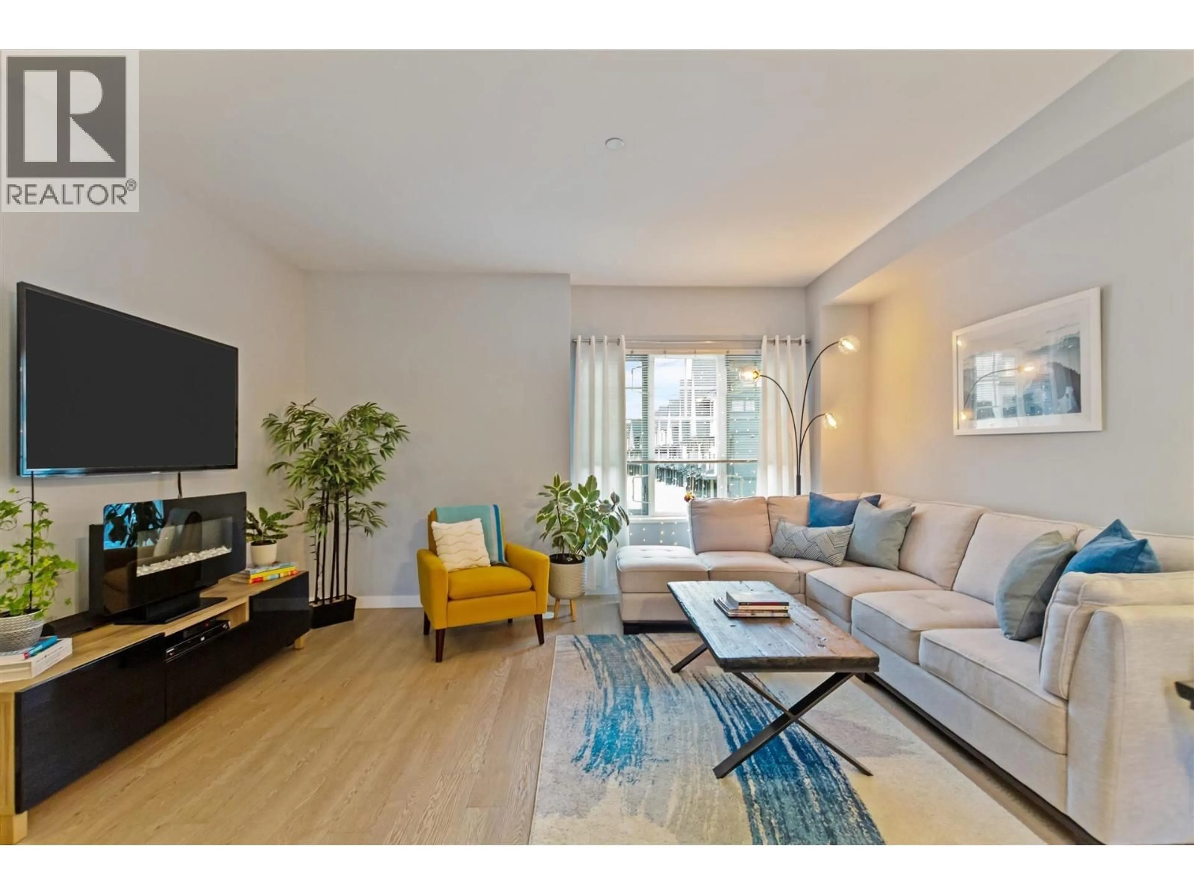 Living room with furniture, wood/laminate floor for 202 - 19451 SUTTON AVENUE, Pitt Meadows British Columbia V3Y0G6