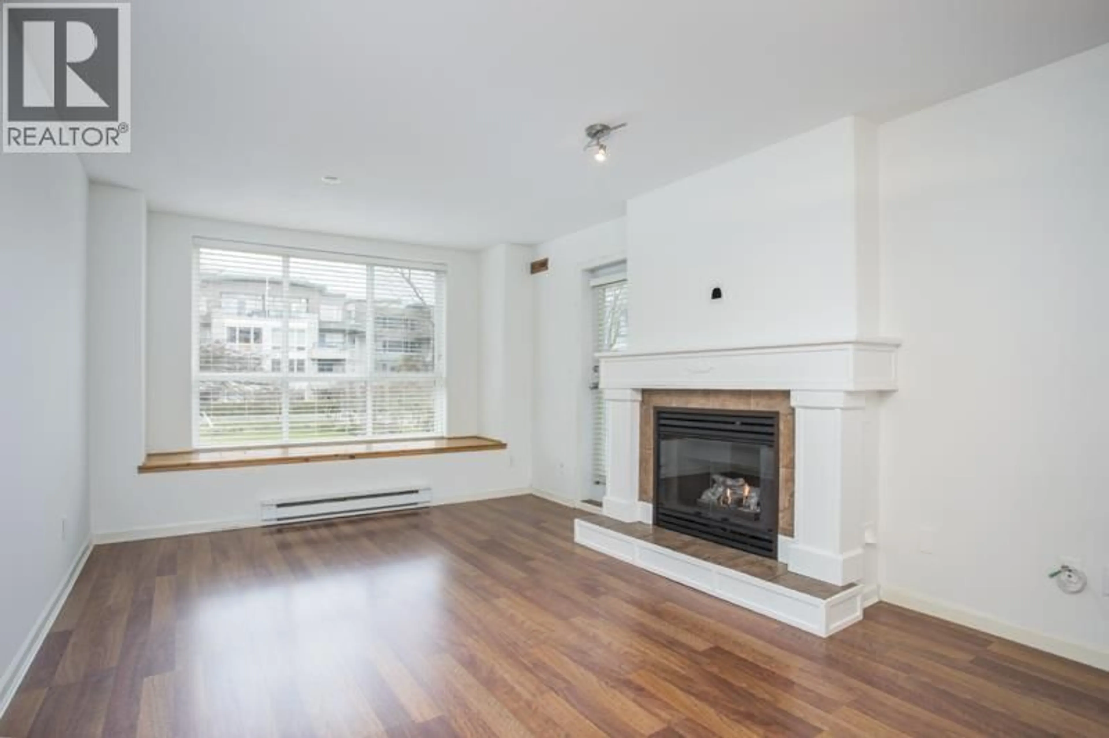 Living room with furniture, wood/laminate floor for 212 - 12633 NO. 2 ROAD, Richmond British Columbia V7E6N5