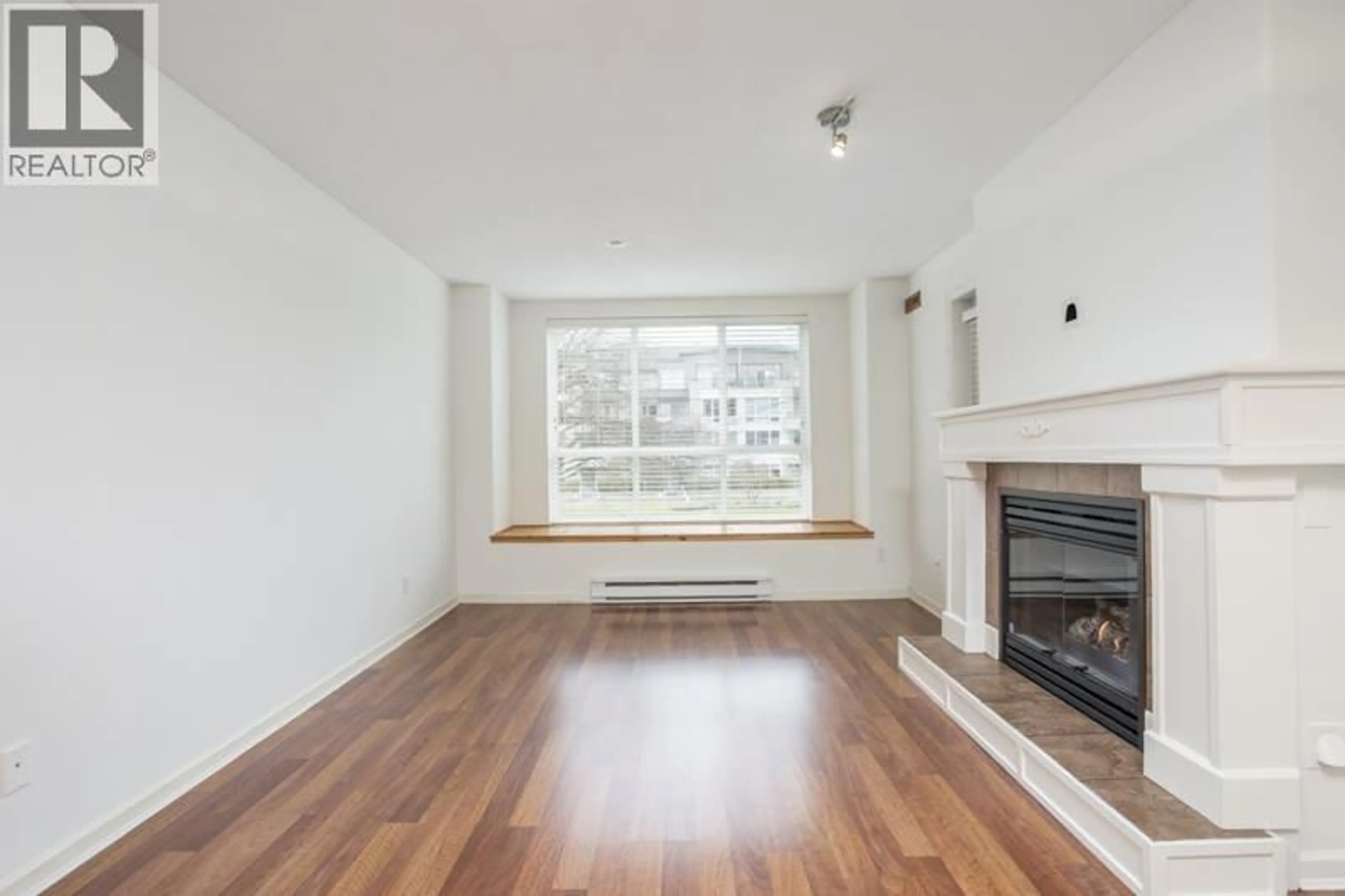 Living room with furniture, wood/laminate floor for 212 - 12633 NO. 2 ROAD, Richmond British Columbia V7E6N5